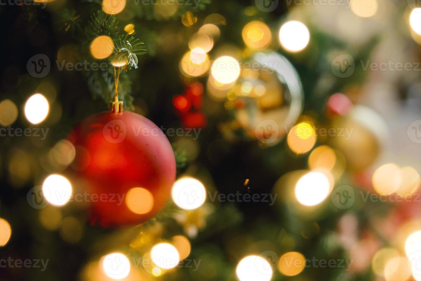 Red and sivlver decoration on Christmas tree at home interior. Holiday background with bokeh lights photo