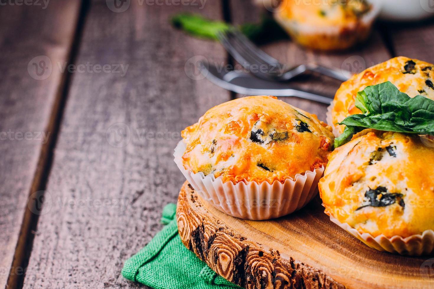 Muffins with Spinach and Cheese on Wooden Table Background. Healthy Breakfast Food Concept photo