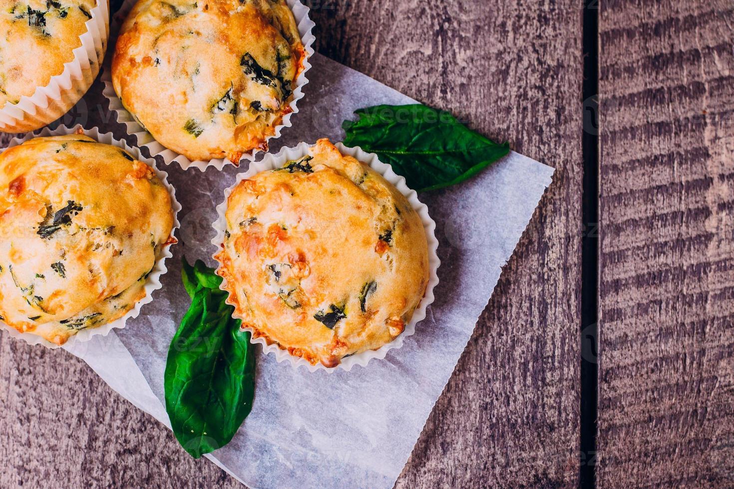 Muffins with Spinach and Cheese on Wooden Table Background. Healthy Breakfast Food Concept. photo