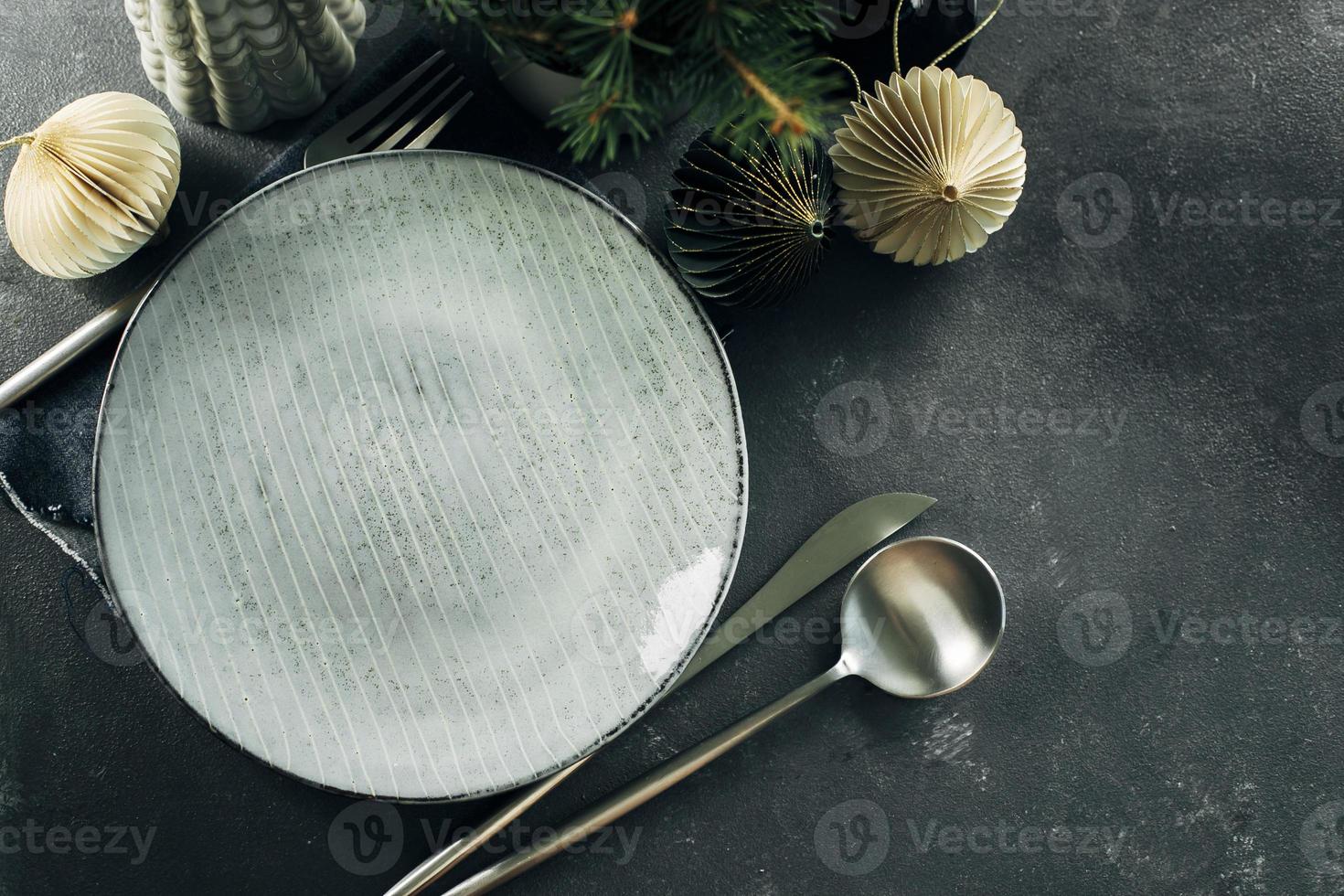 Christmas or New Year table setting with empty plate and silver cutlery. Flat lay, top view, copy space. Christmas dinner, new year party concept. photo