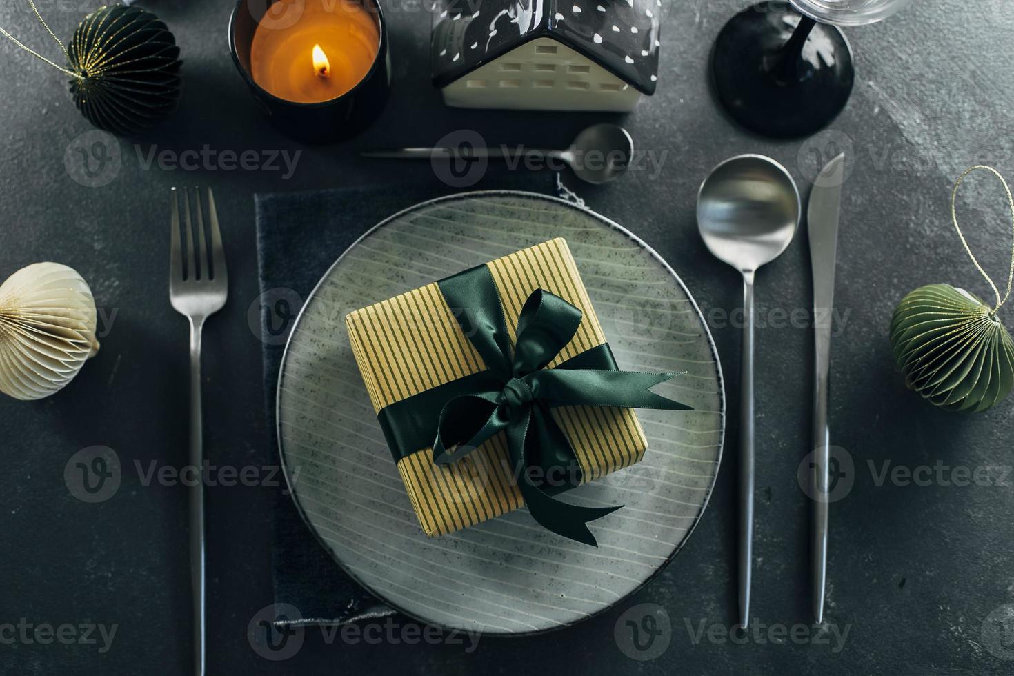 Christmas or New Year table setting on dark background. Flat lay, top view. Christmas dinner, new year party concept. photo