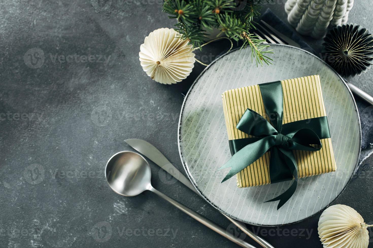 Christmas or New Year table setting on dark background. Flat lay, top view, copy space. Christmas dinner, new year party concept. photo