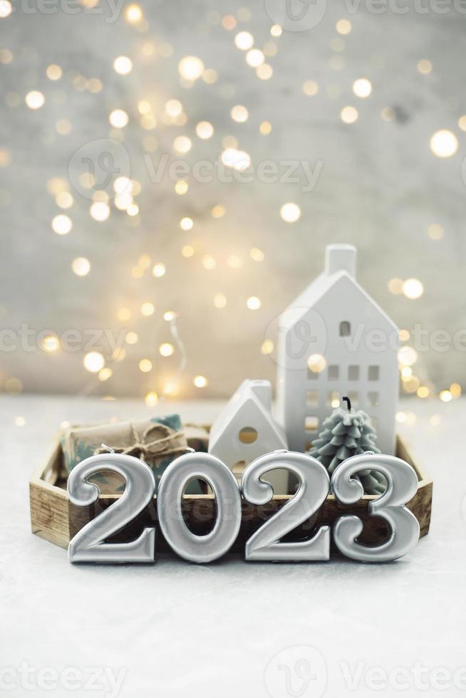 Christmas and New Year card. Number 2023 on holiday background. Christmas lights bokeh background. Holiday postcard. Happy New Year 2023 Card Concept photo