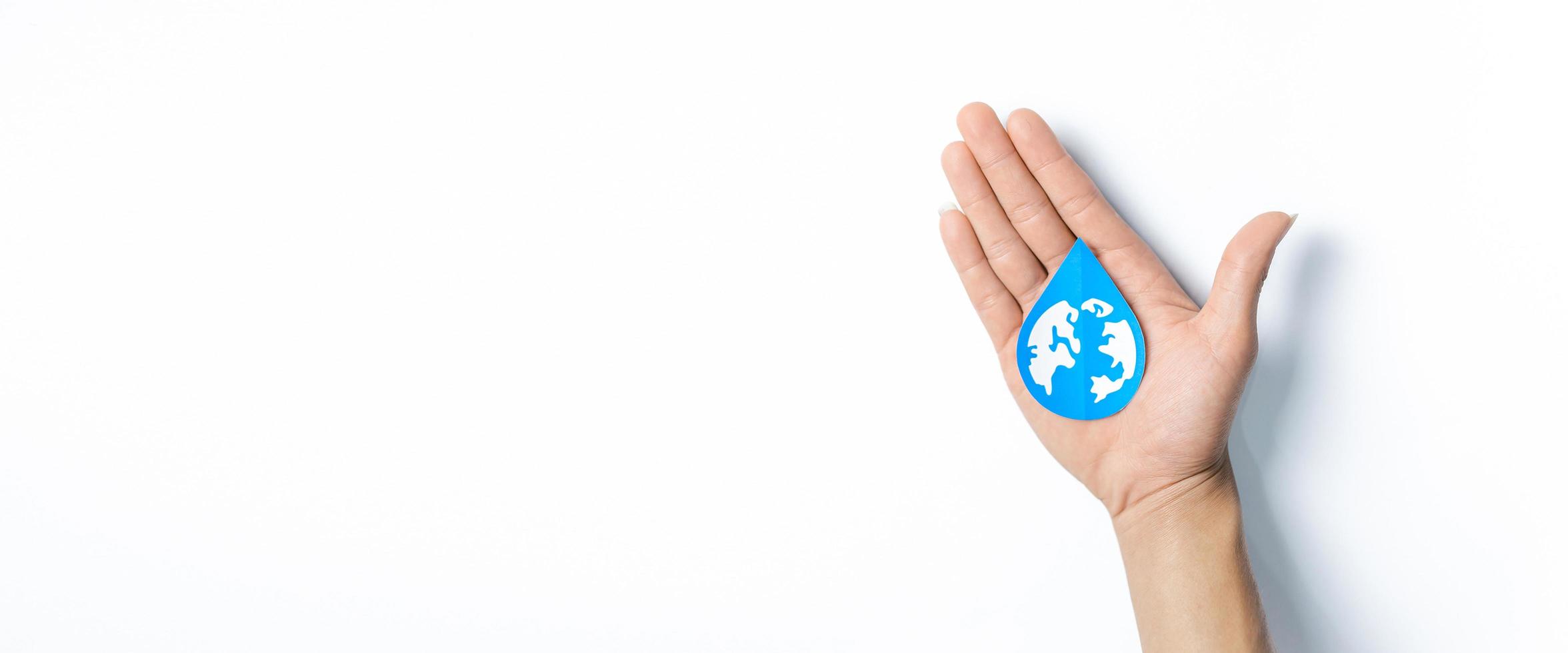 Hands holding water drop paper cut, Washing hand, Hand sanitizer and Hygiene. World water day, Saving water and world environmental protection concept photo