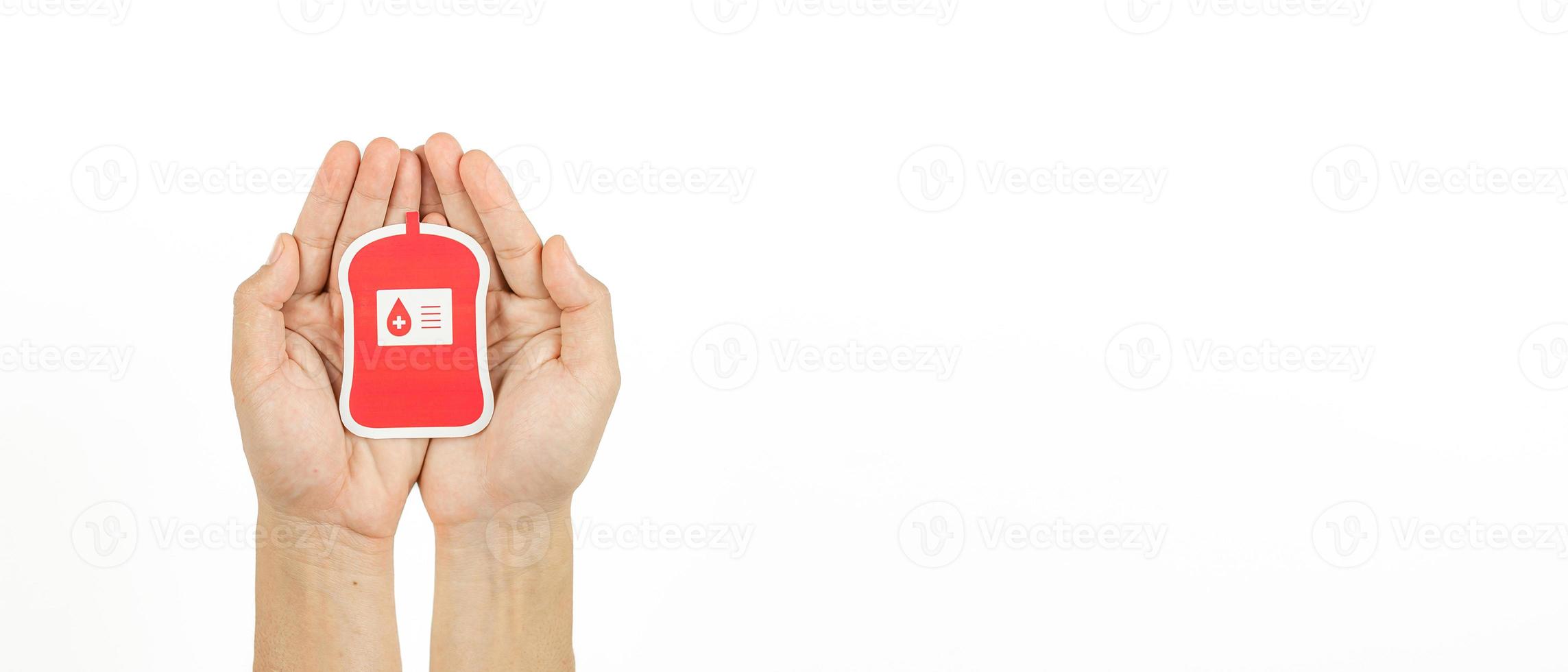 Hands holding blood pack paper cut on white background, Blood transfusion, World blood donor day. Blood Donation and Saving life Concept photo