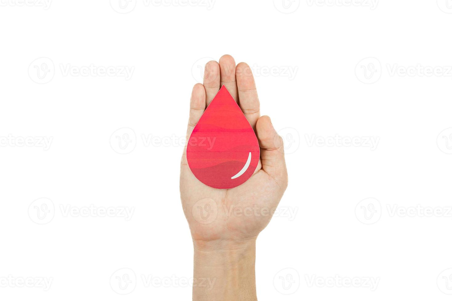 Hands holding blood drop paper cut on white background, Blood transfusion, World blood donor day. Blood Donation and Saving life Concept photo