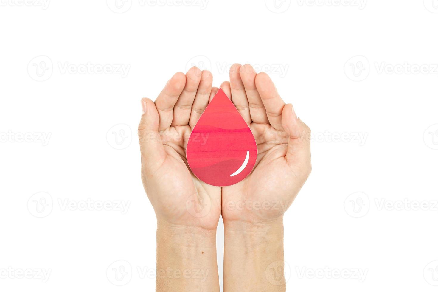 Hands holding blood drop paper cut on white background, Blood transfusion, World blood donor day. Blood Donation and Saving life Concept photo