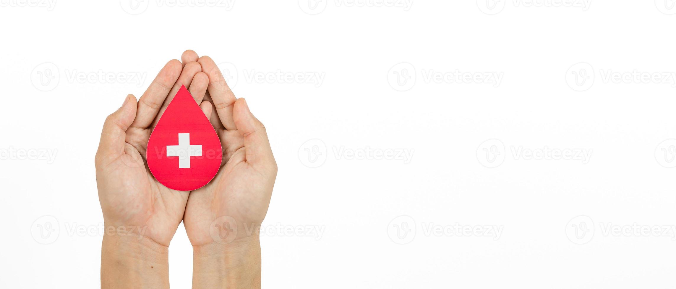 Hands holding blood drop paper cut on white background, Blood transfusion, World blood donor day. Blood Donation and Saving life Concept photo