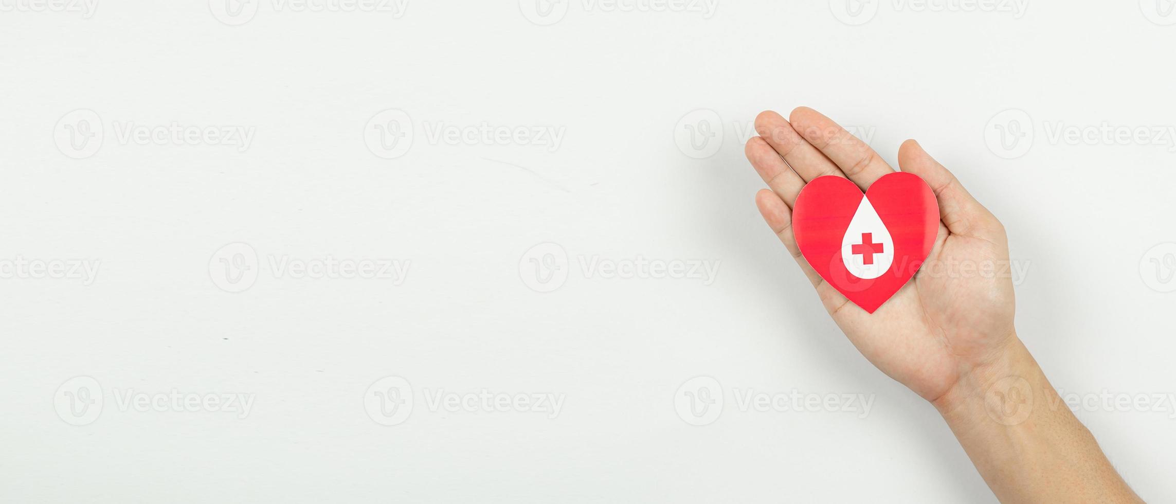 Hands holding heart for giving life paper cut on white background, Blood transfusion, World blood donor day. Blood Donation Concept photo