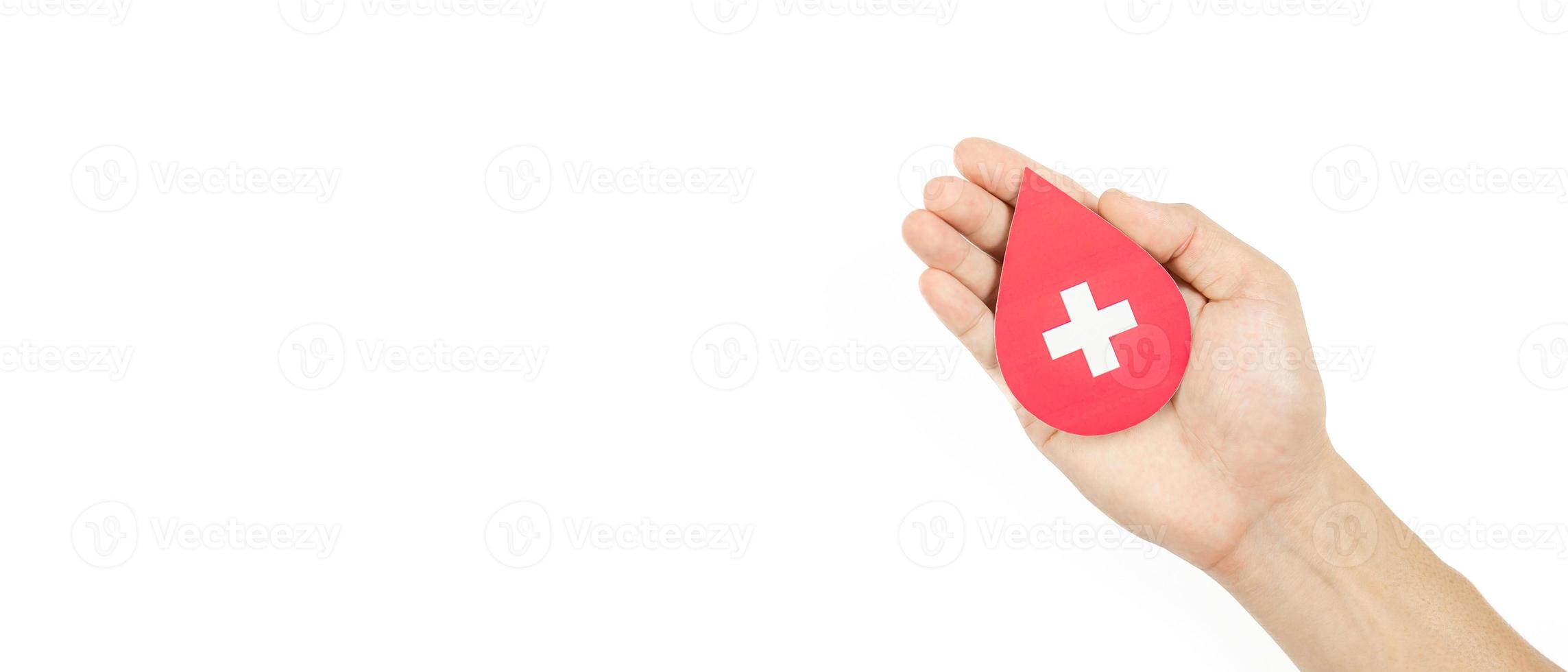 Hands holding blood drop paper cut on white background, Blood transfusion, World blood donor day. Blood Donation and Saving life Concept photo