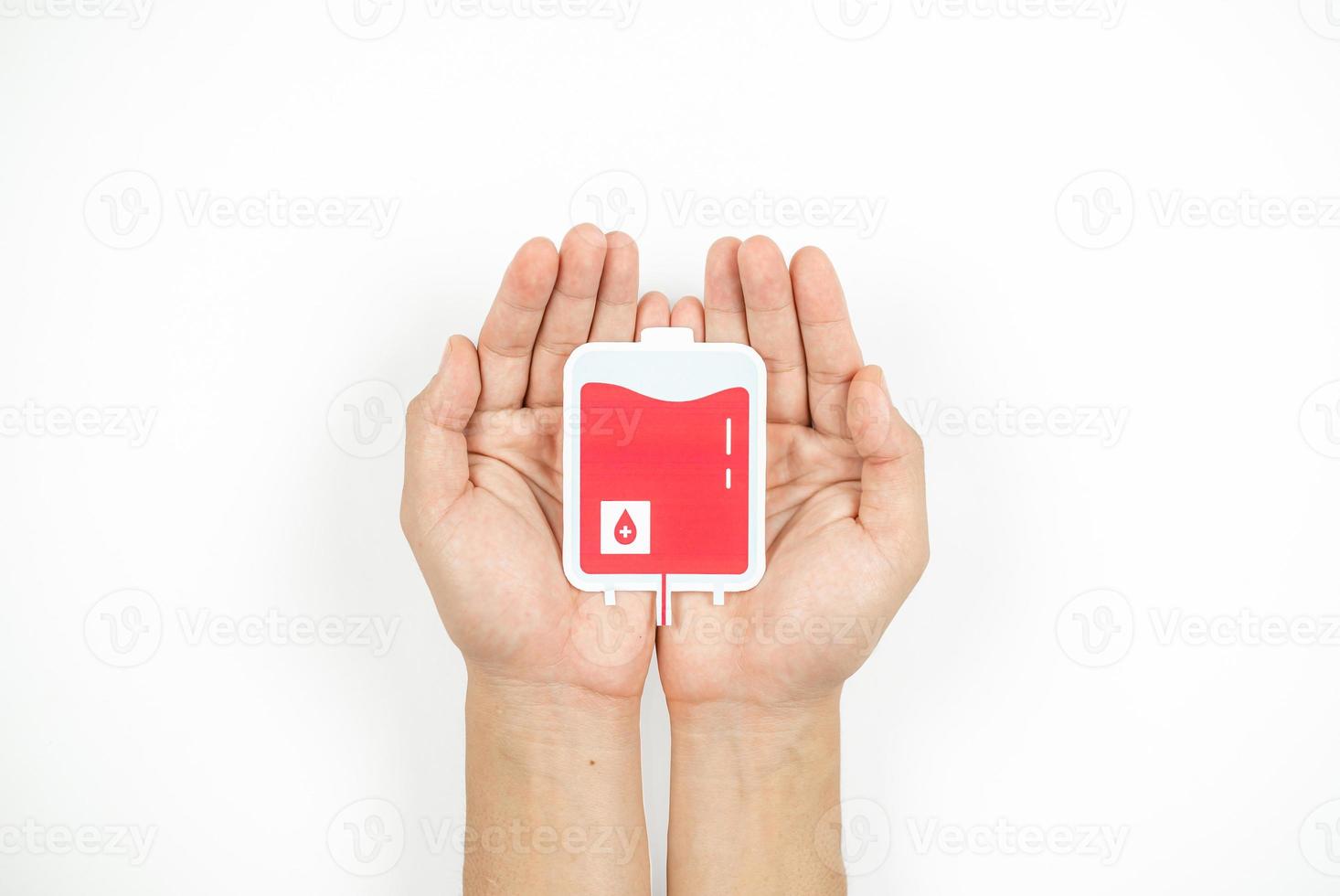 Hands holding blood pack paper cut on white background, Blood transfusion, World blood donor day. Blood Donation and Saving life Concept photo