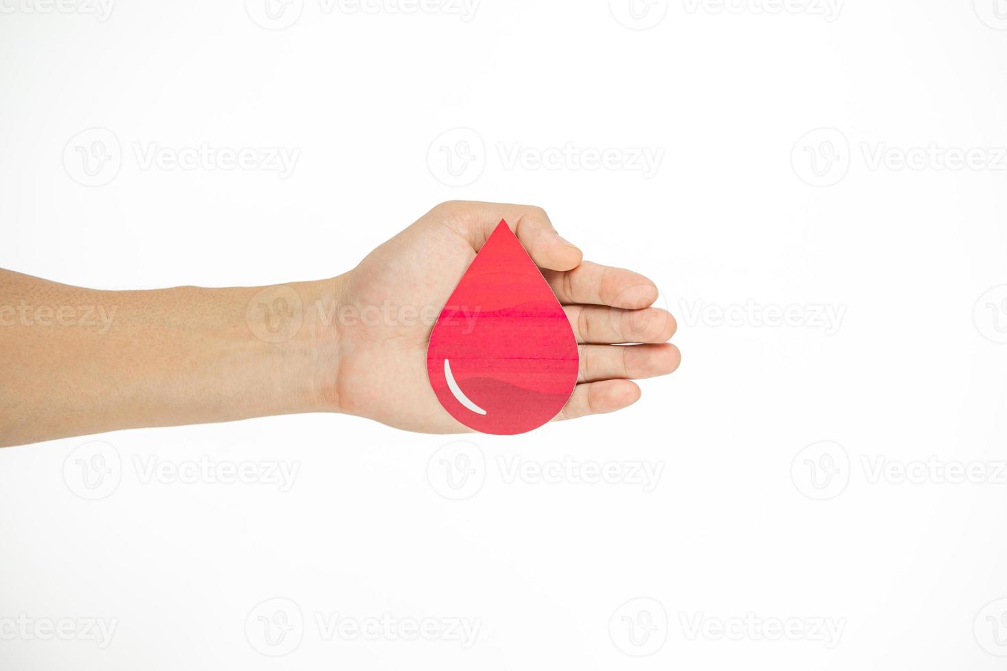 Hands holding blood drop paper cut on white background, Blood transfusion, World blood donor day. Blood Donation and Saving life Concept photo