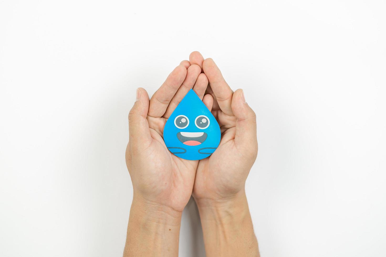 Hands holding water drop paper cut, Washing hand, Hand sanitizer and Hygiene. World water day, Saving water and world environmental protection concept photo