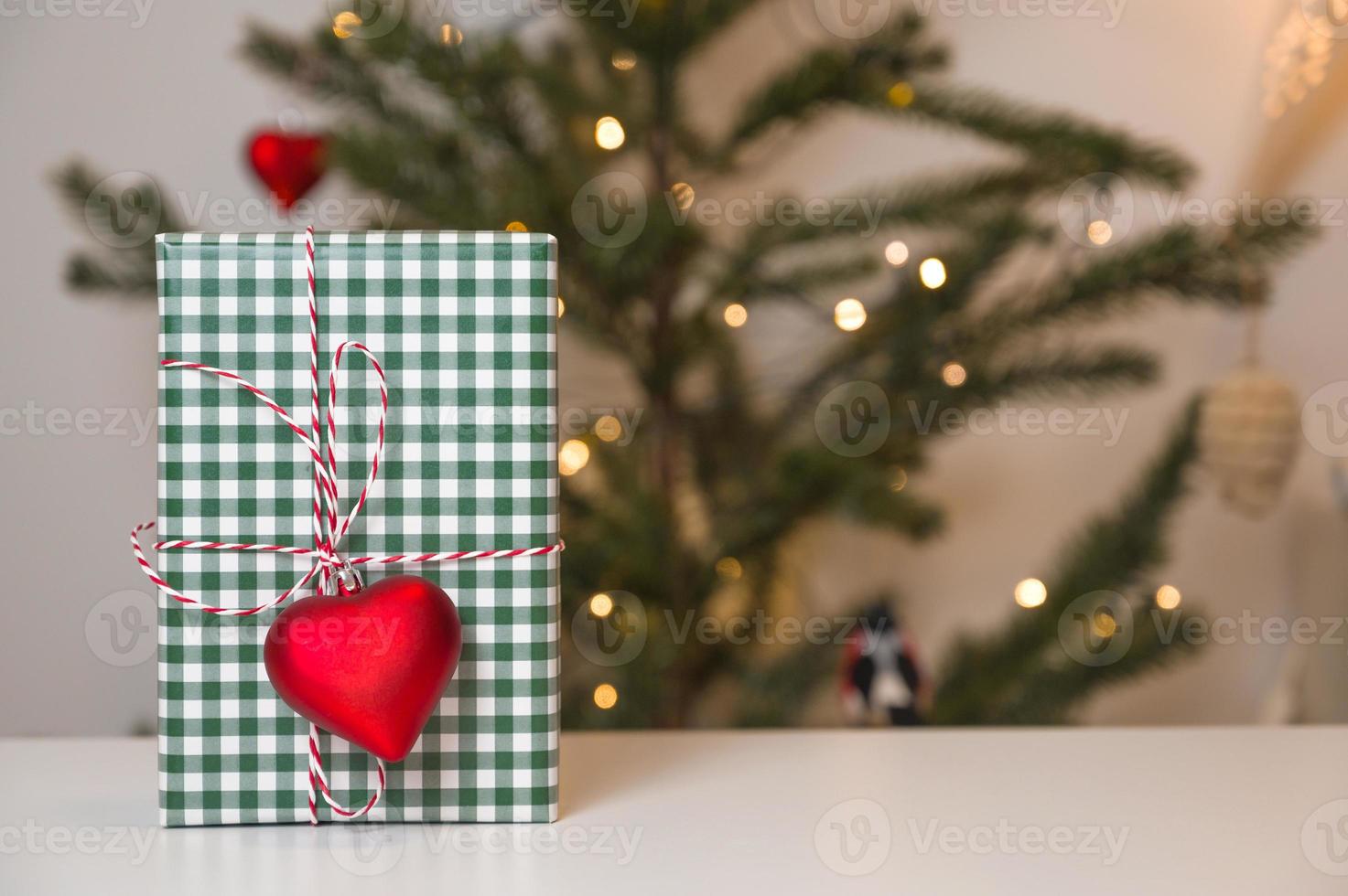 Copy space christmas banner with red,green and white chrostmas box near xmas tree photo