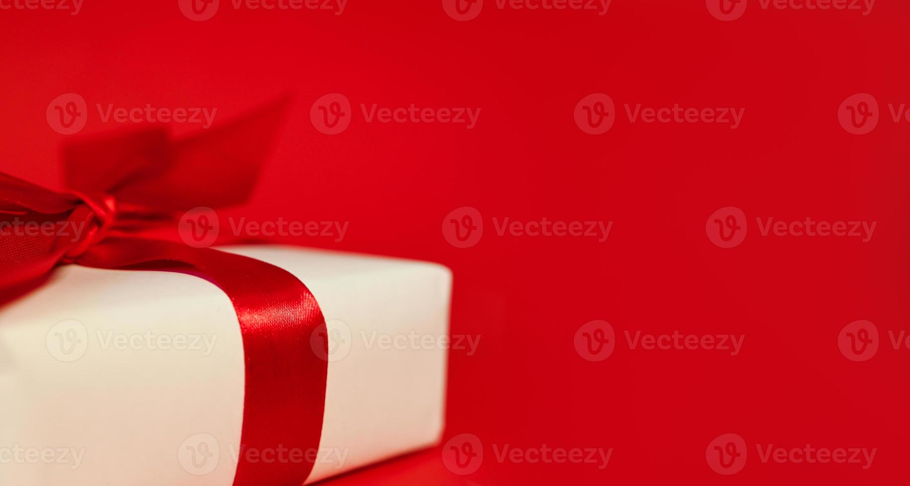 Holiday banner. White gift with a red bow. Mockup photo