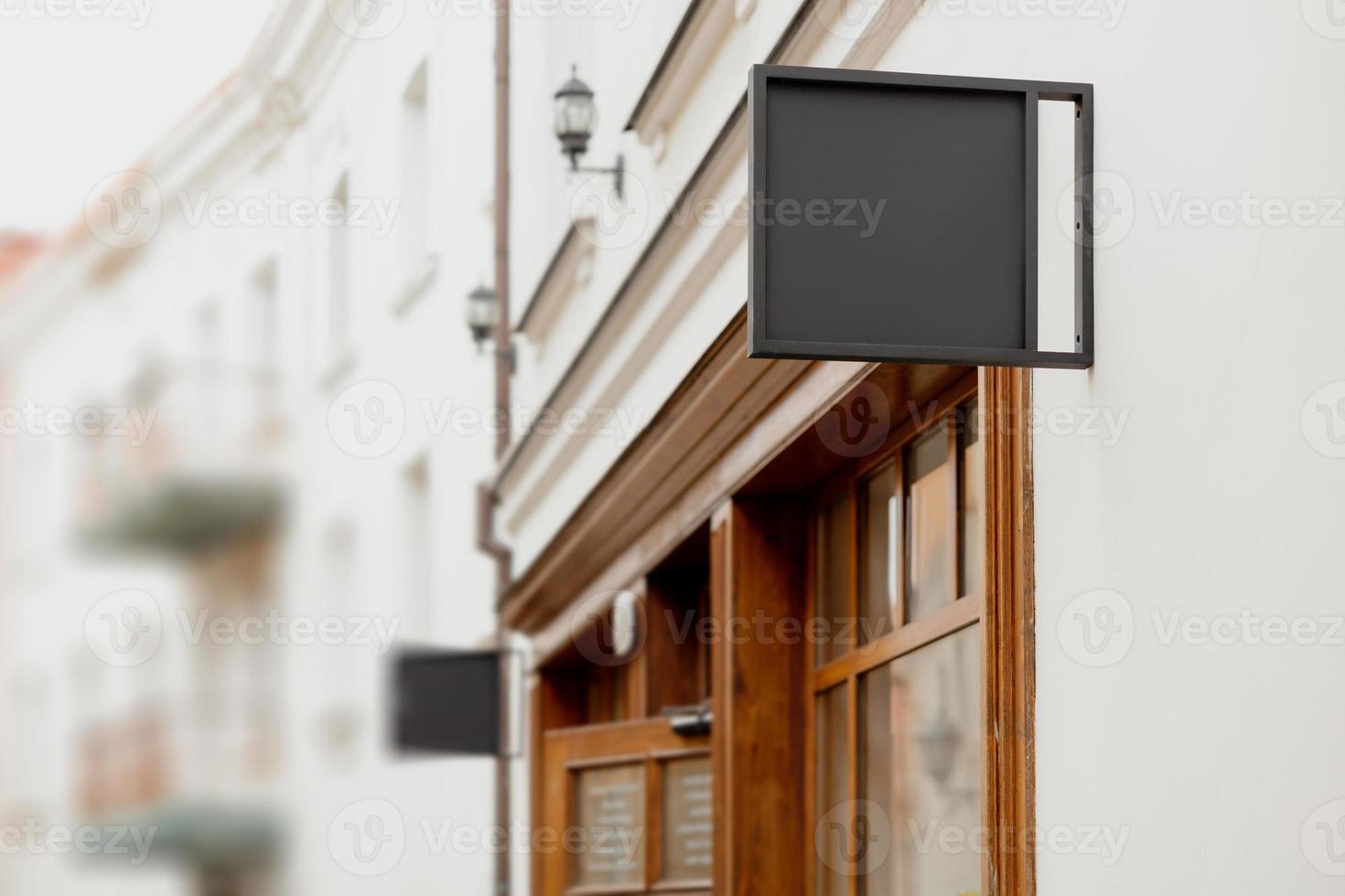 Blank signboard mock up, on the facade. Copy space for your store sign or logo. Modern empty outdoor signage, mockup to add company logo. Black square store signboard on white wall. photo