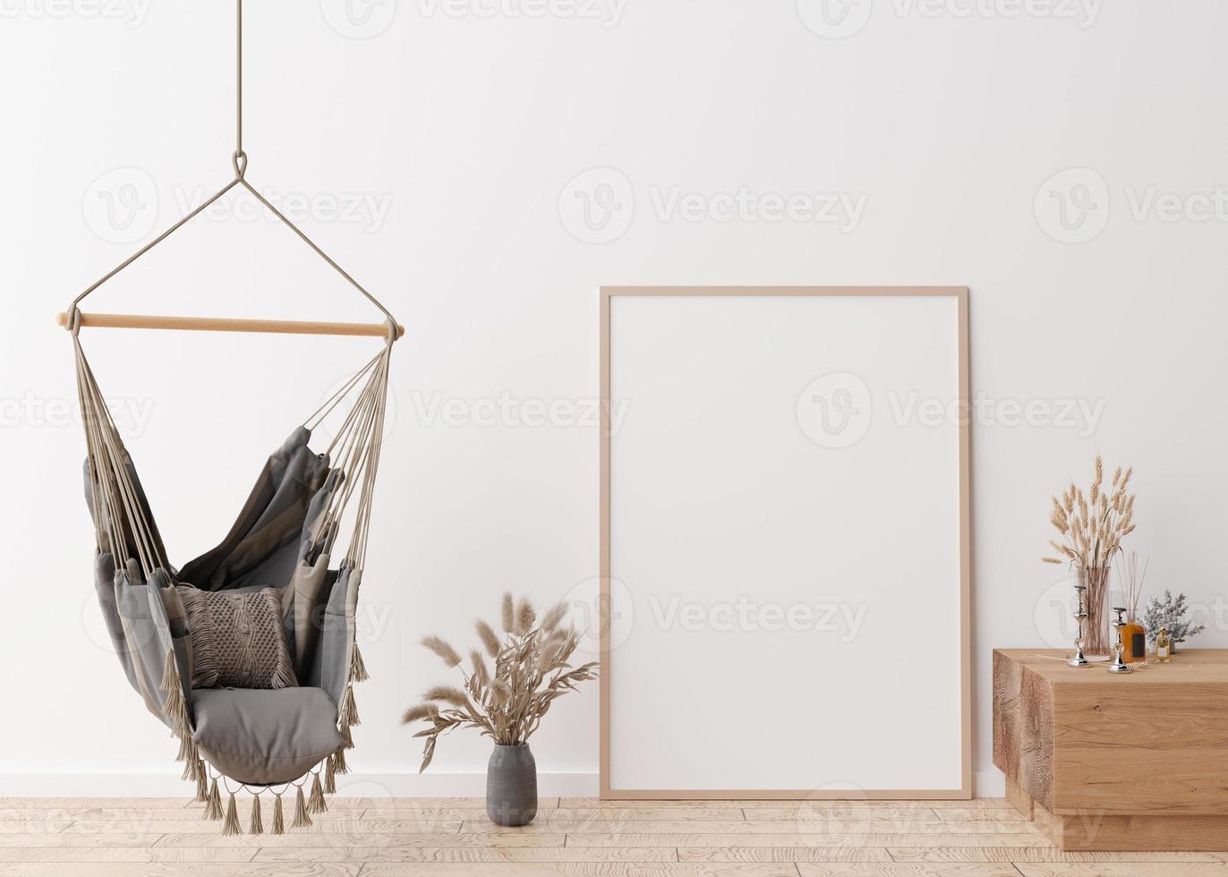 Empty vertical picture frame standing on parquet floor in modern living room. Mock up interior in scandinavian, boho style. Free space for picture. Vases with dried grass, hanging chair. 3D rendering. photo