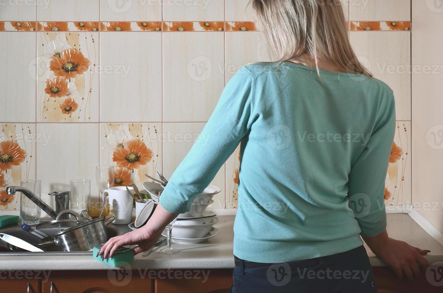 Fragment of the female body at the kitchen counter, filled with photo