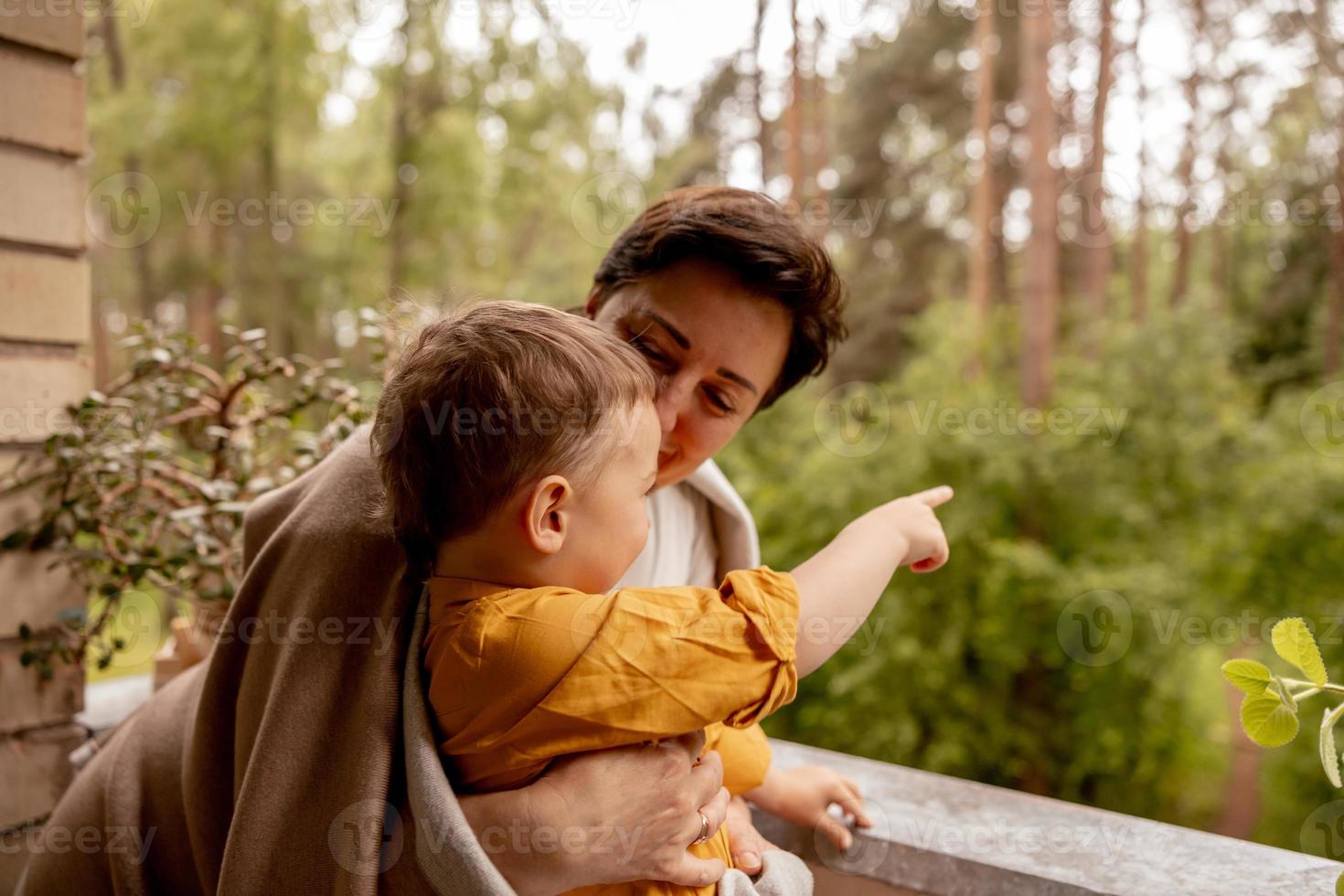 Happy grandmother and grandson enjoy time together. Positive middle age woman spending time with little, cute grandchild, having fun. 50-year-old grandma with grandkid. Multi-generational family. photo