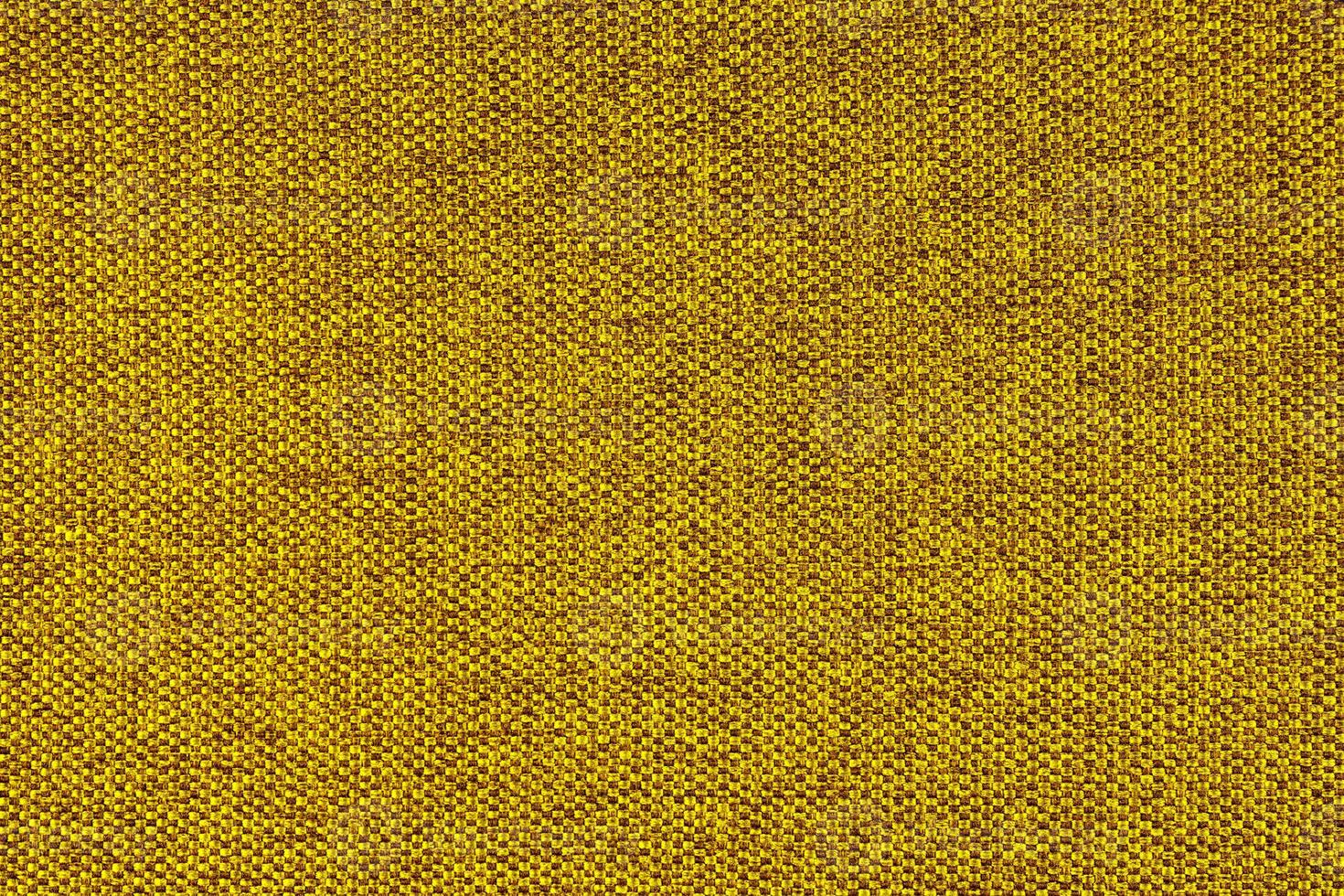 cierre la textura de la tapicería de tejido grueso amarillo. fondo textil decorativo foto