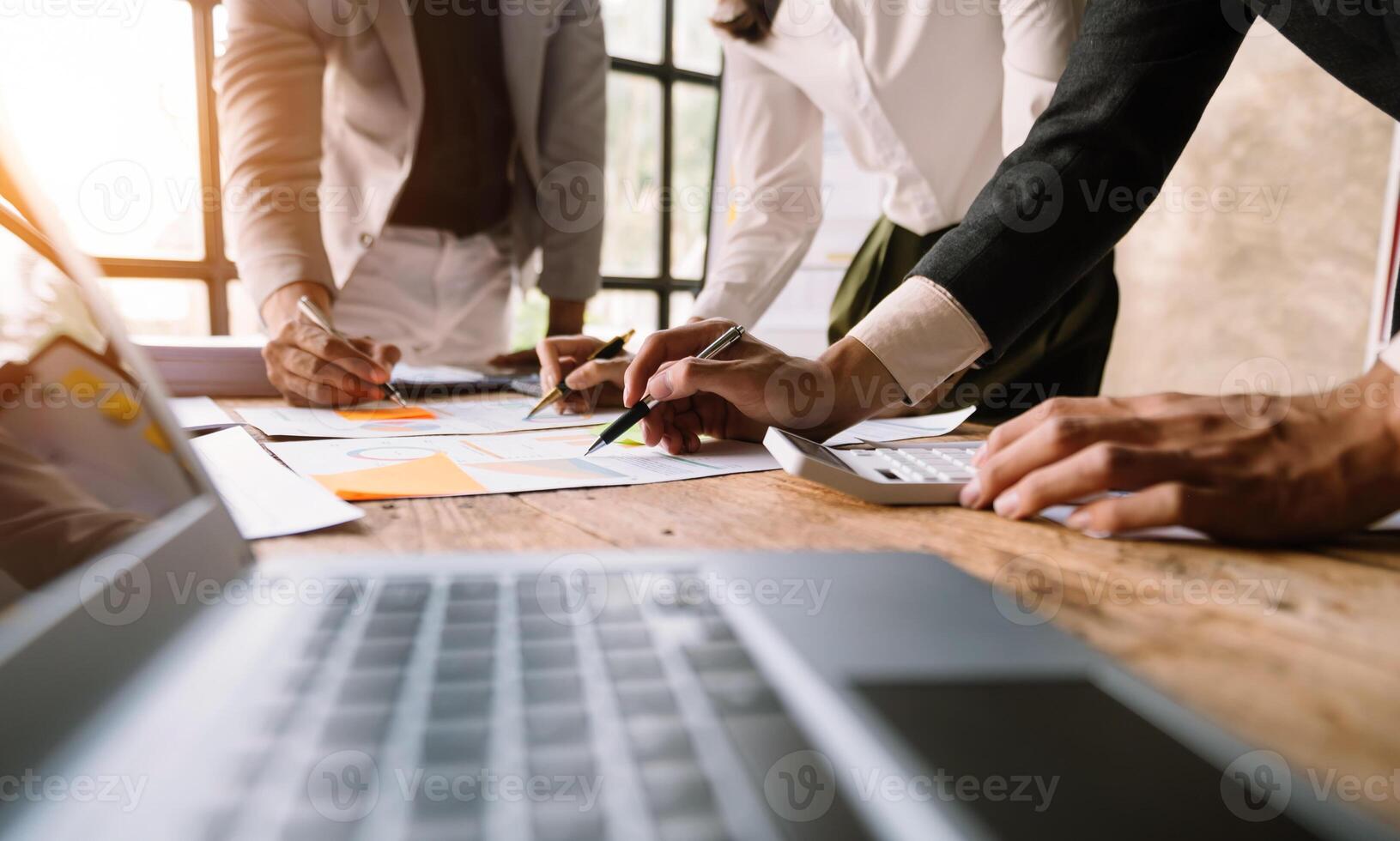 Business team meeting. professional investor working new start up project. Finance task. with smart phone and laptop and digital tablet computer  in morning light photo