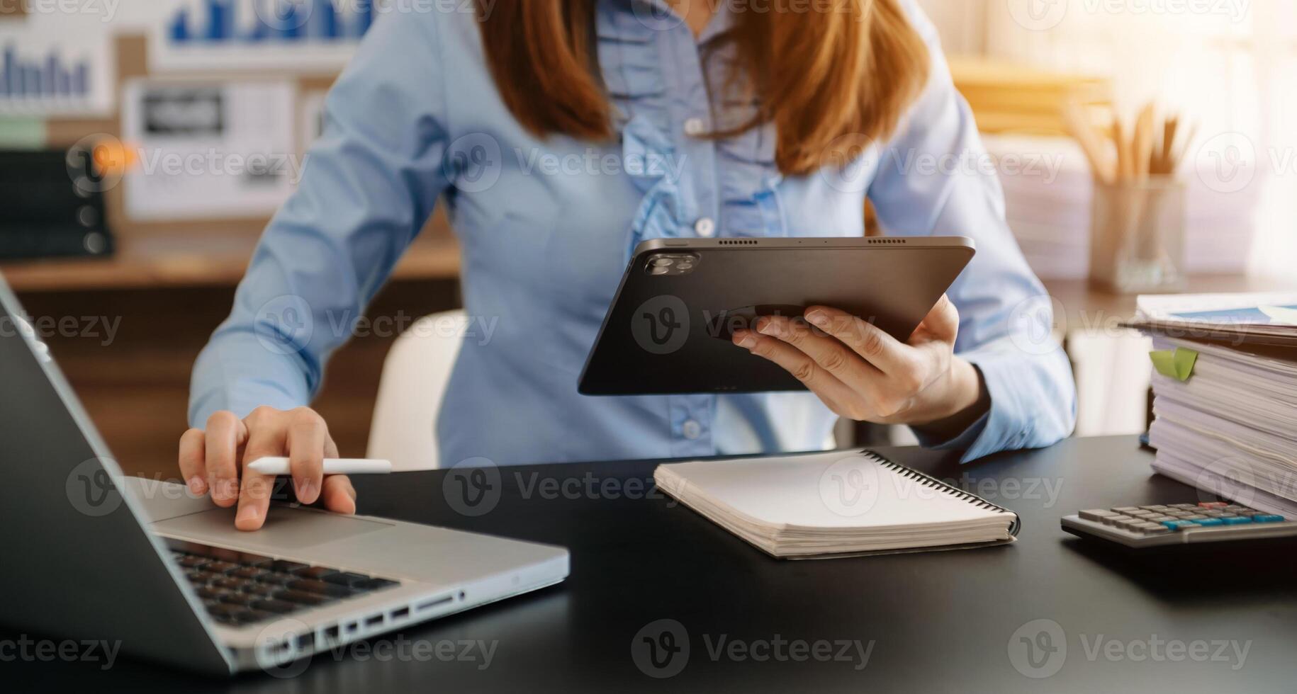 Businesswoman working with VR wide blank screen tablet, computer and smart phone on office blur background. photo