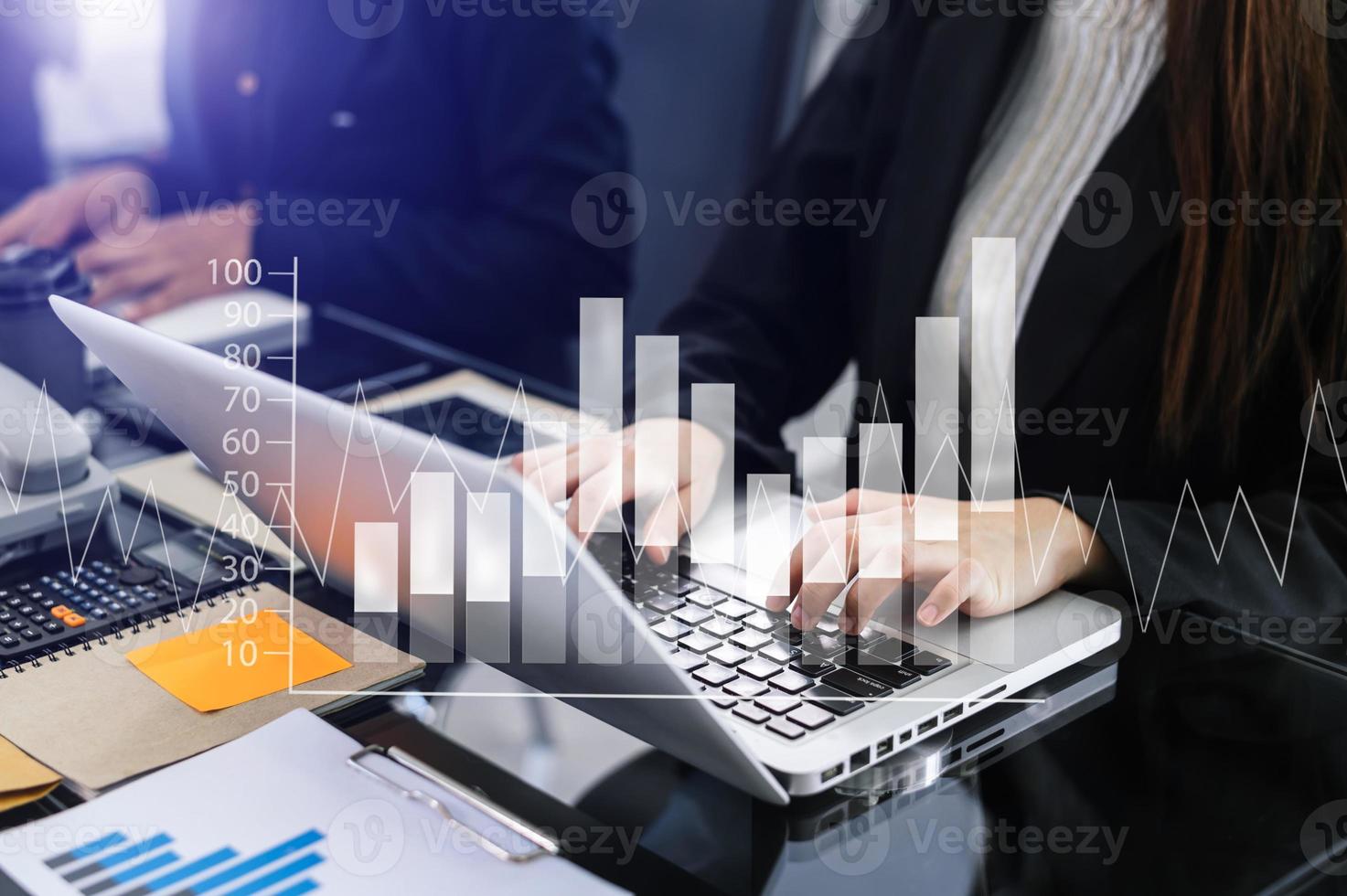Business documents on office table with smart phone and calculator digital tablet and graph photo