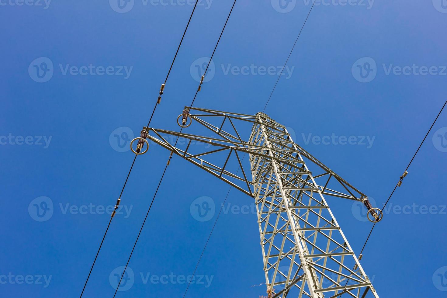 Electricity transmission power lines at sunset. High voltage tower photo