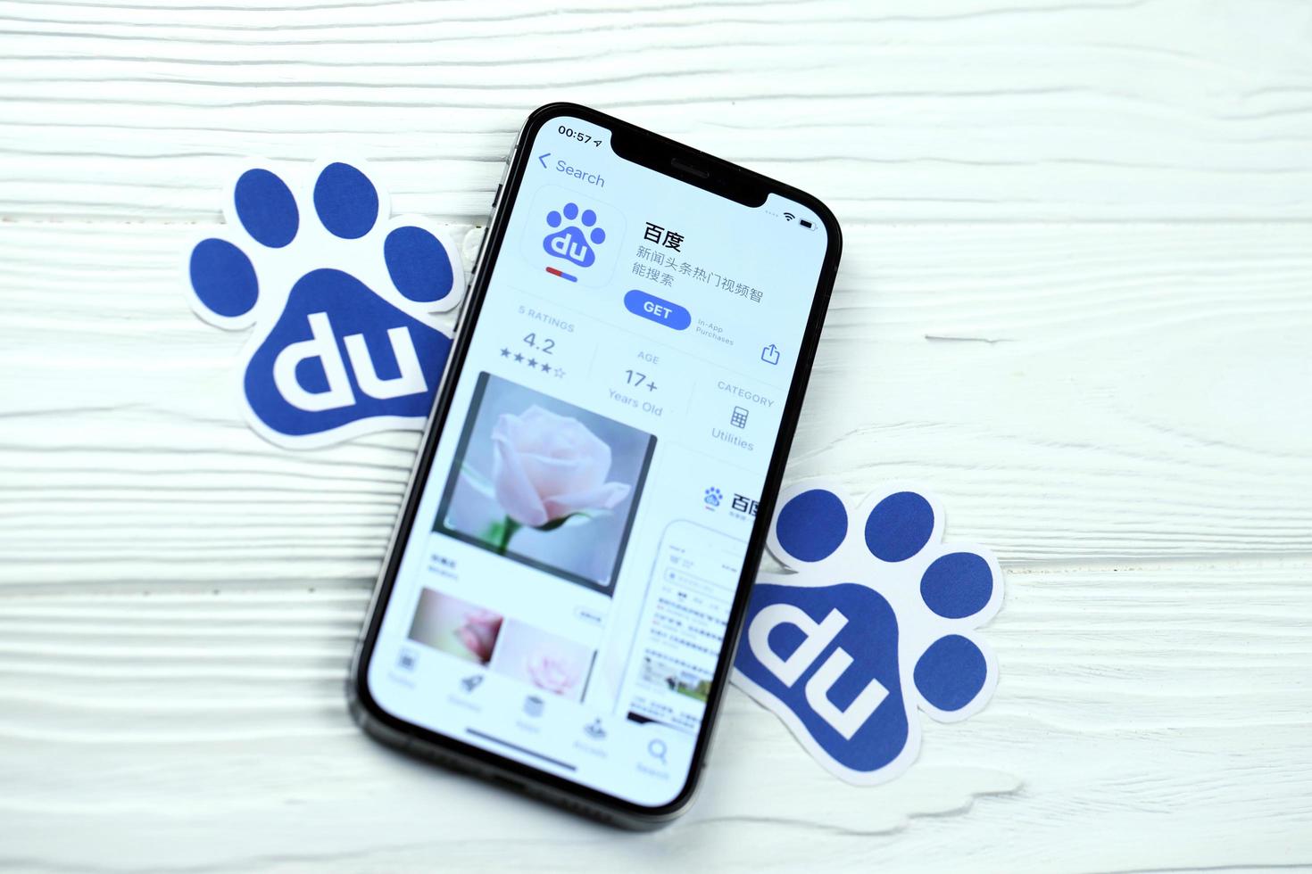 KHARKOV, UKRAINE - MARCH 5, 2021 Baidu icon and application from App store on iPhone 12 pro display screen on white table photo