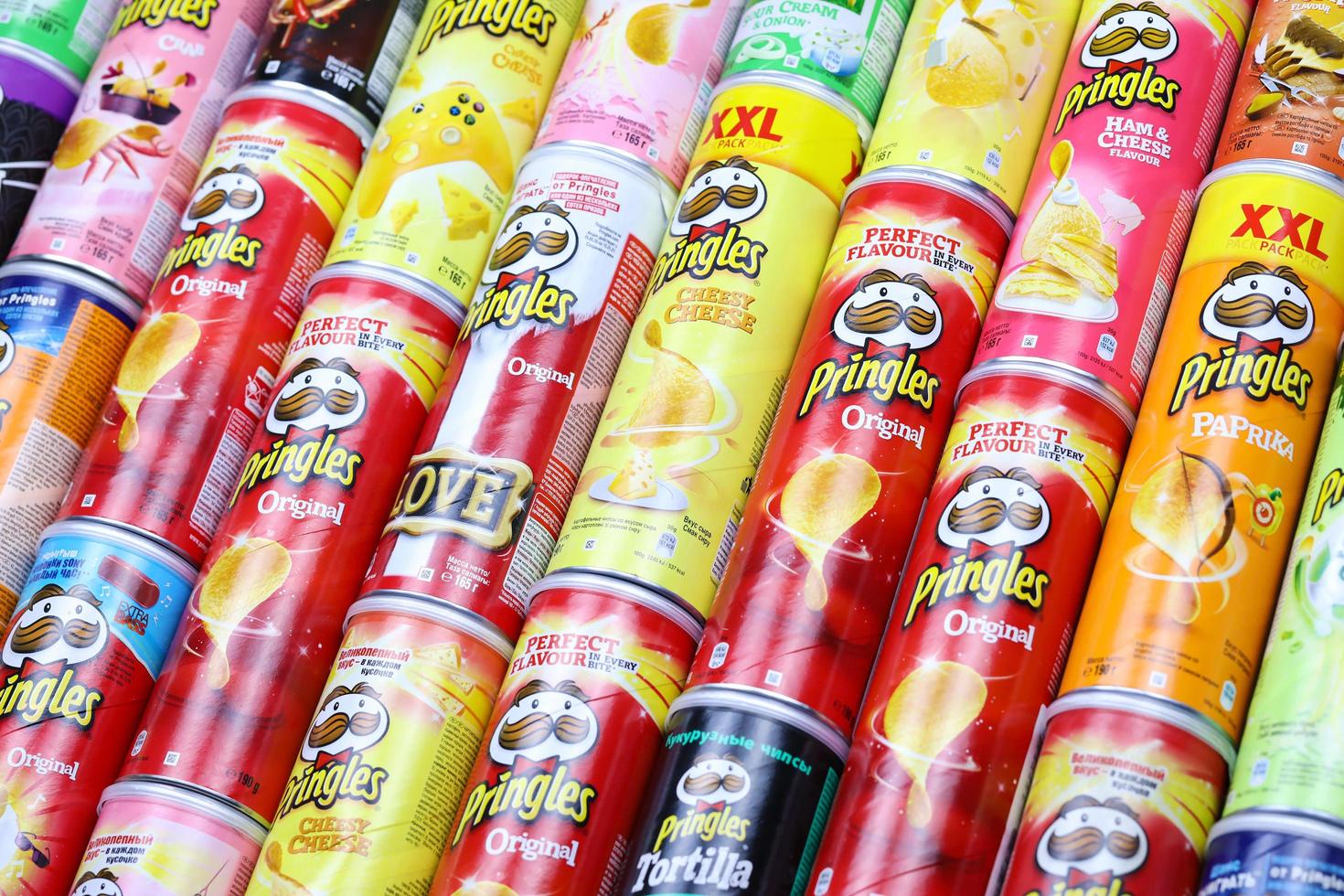 KHARKOV, UKRAINE - MARCH 30, 2021 Many Pringles cylinder chips boxes with varios colors and flavours. American brand of stackable potato-based crisps photo