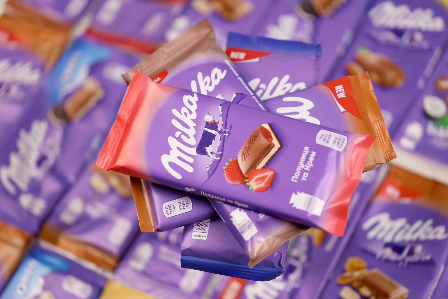 KHARKOV, UKRAINE - DECEMBER 8, 2020 Many wrappings of purple Milka chocolate. Milka is a Swiss brand of chocolate confection manufactured by company Mondelez International photo