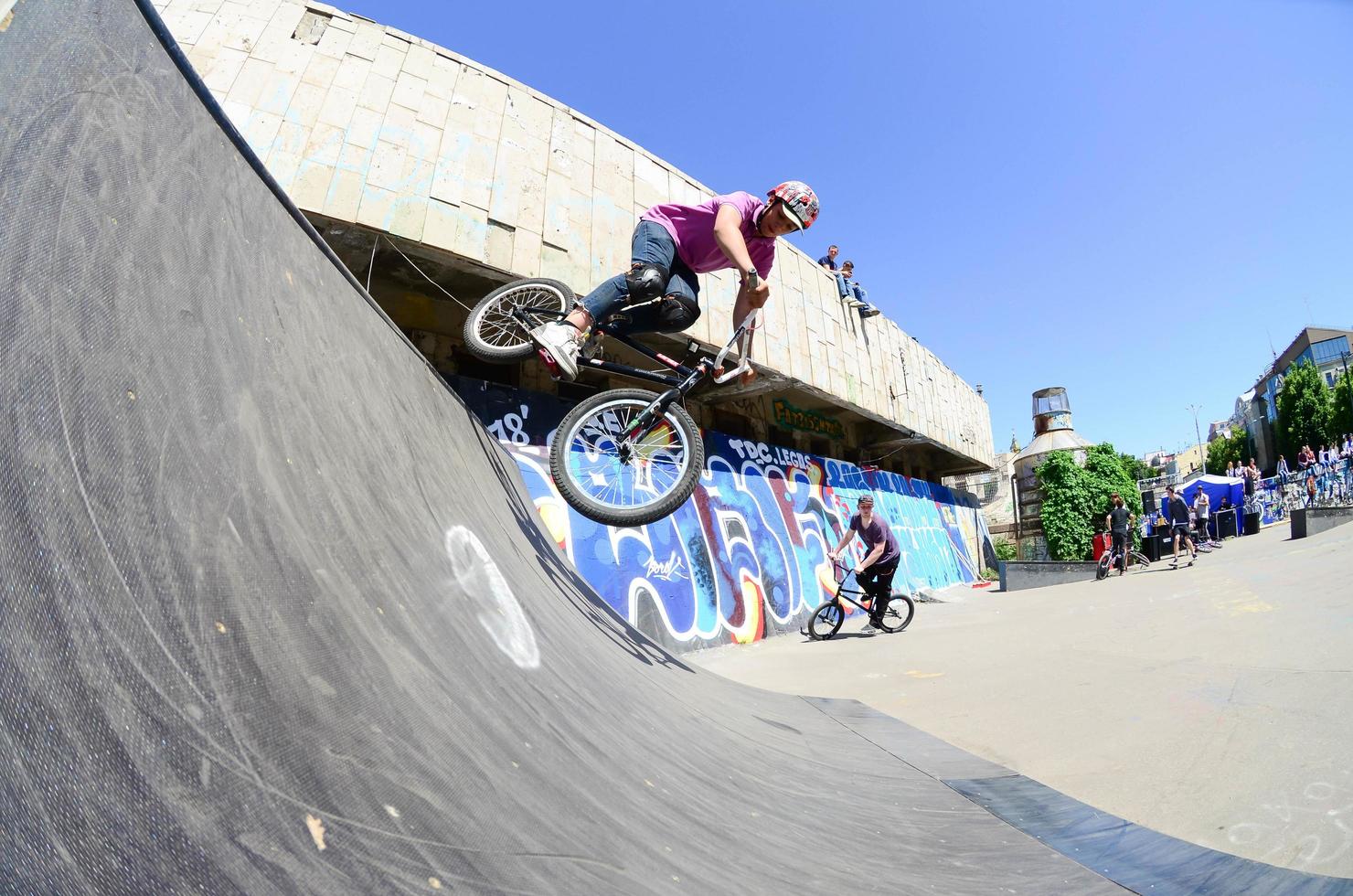 KHARKIV, UKRAINE - 27 MAY, 2018 Freestyle BMX riders in a skatepark during the annual festival of street cultures photo