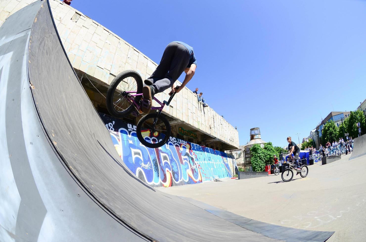 KHARKIV, UKRAINE - 27 MAY, 2018 Freestyle BMX riders in a skatepark during the annual festival of street cultures photo