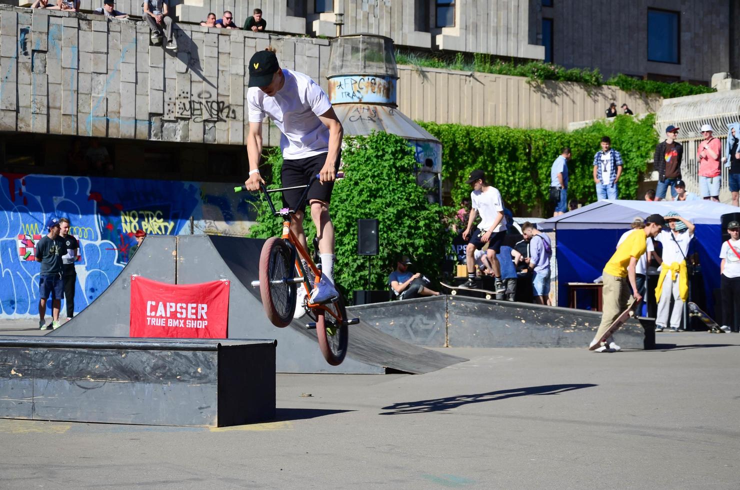 KHARKIV, UKRAINE - 27 MAY, 2018 Freestyle BMX riders in a skatepark during the annual festival of street cultures photo