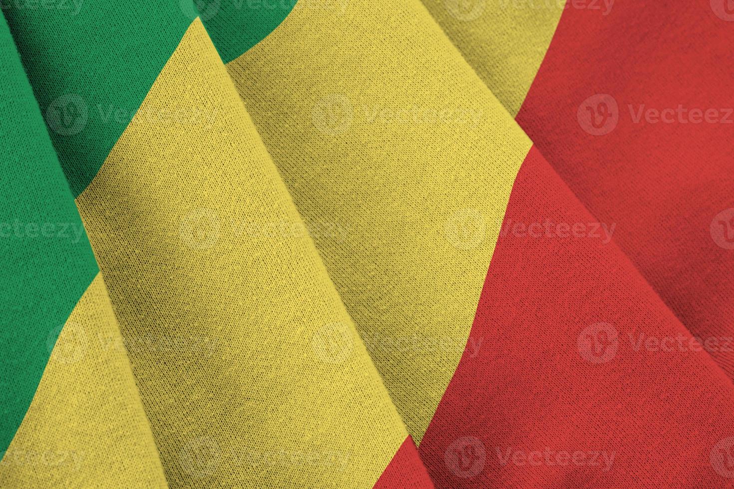 Congo flag with big folds waving close up under the studio light indoors. The official symbols and colors in banner photo