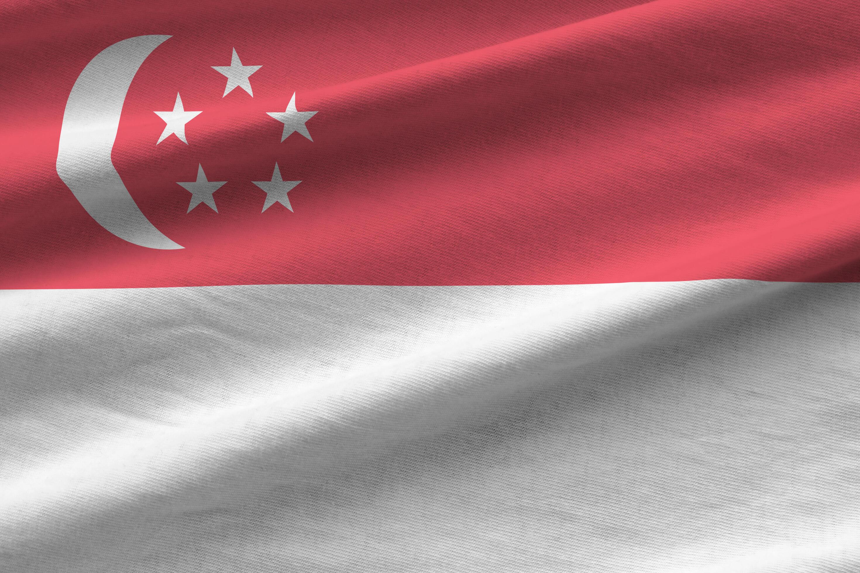 Singapore flag with big folds waving close up under the studio light