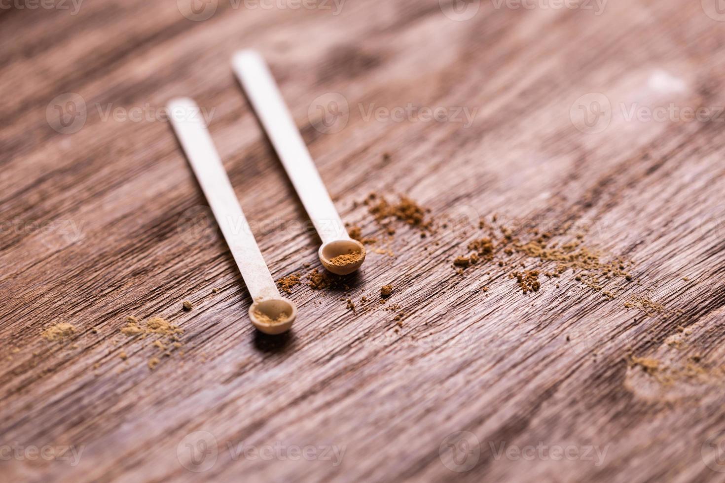 Mineral powder of different colors with a spoon dispenser for make-up on wooden background with copy space photo