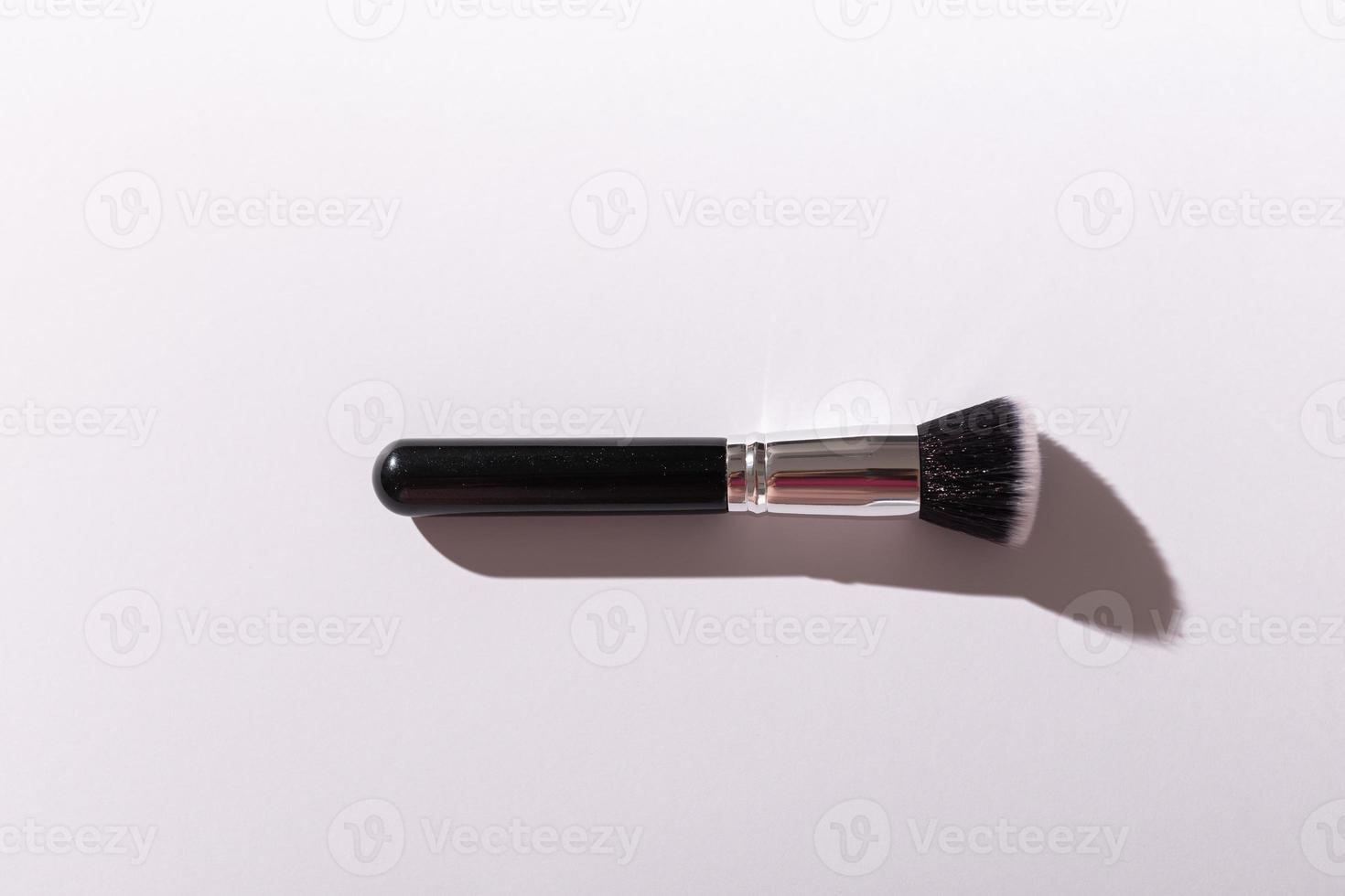 Make up brush on white background, top view. photo