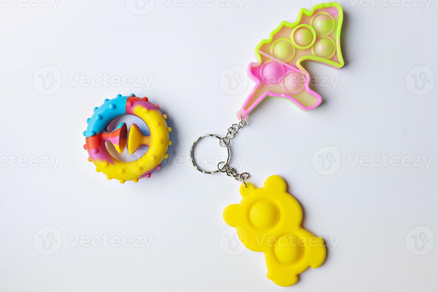 Pop it fidget toy. Multi-colored anti-stress toy with a wing shape on a white background photo