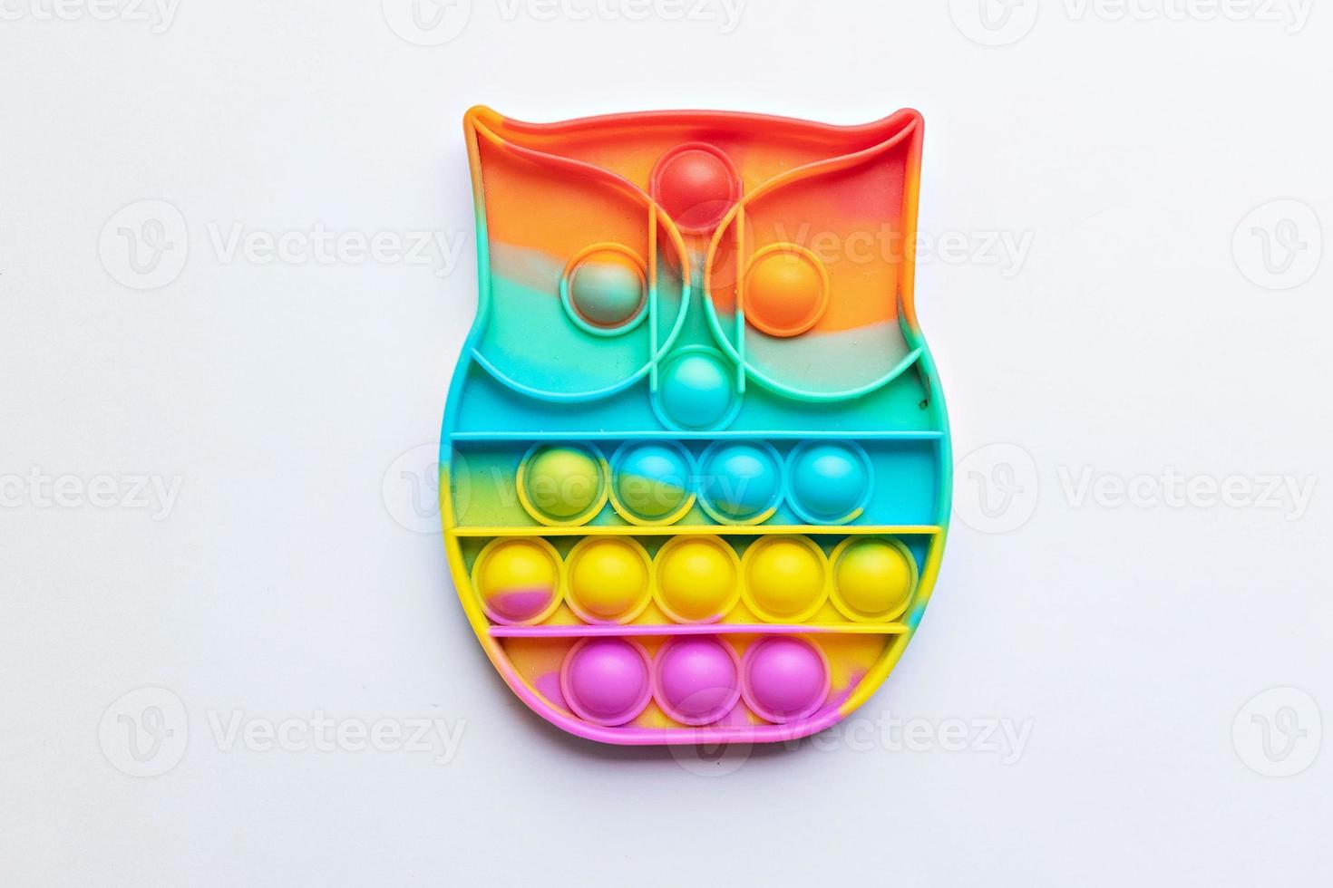 Pop it fidget toy. Multi-colored anti-stress toy with a wing shape on a white background photo