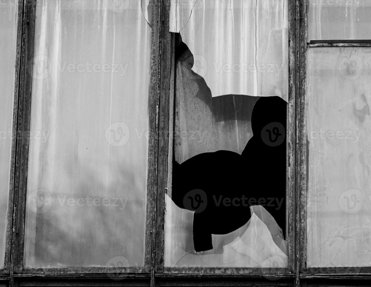 Broken glass in a wooden window photo