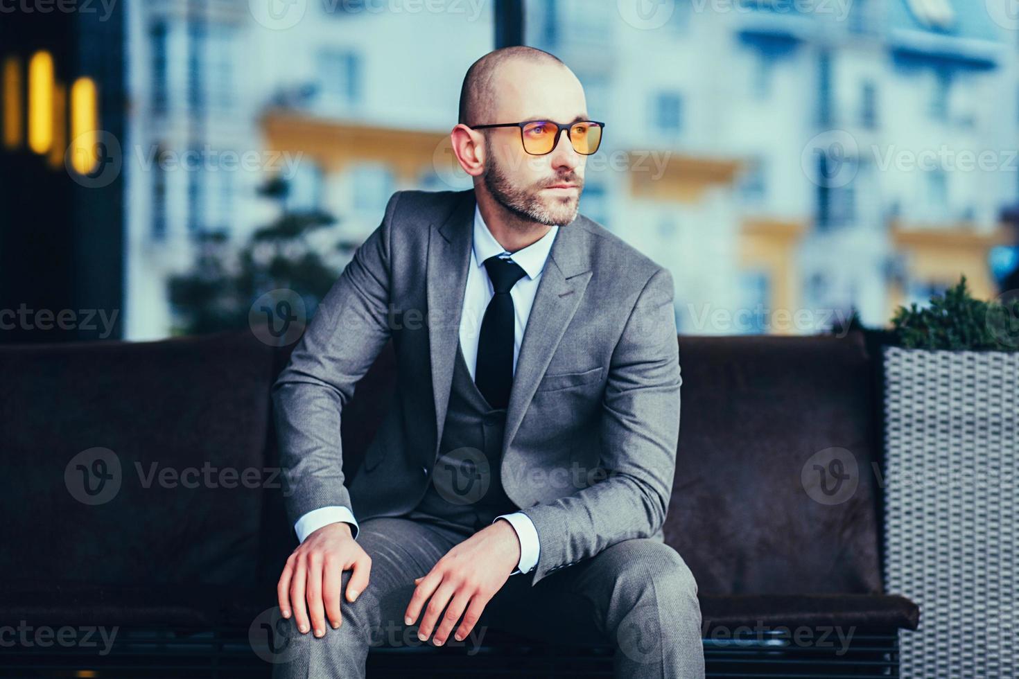 manager sitting in gray suit photo