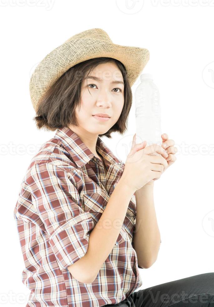 Woman in a plaid shirt holding a water bottle on white background photo