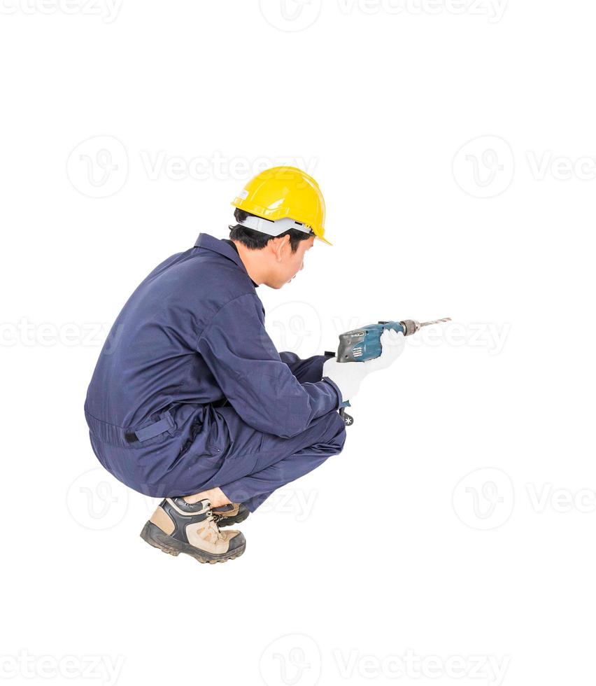 Handyman in unifrom sitting with his electric drill photo