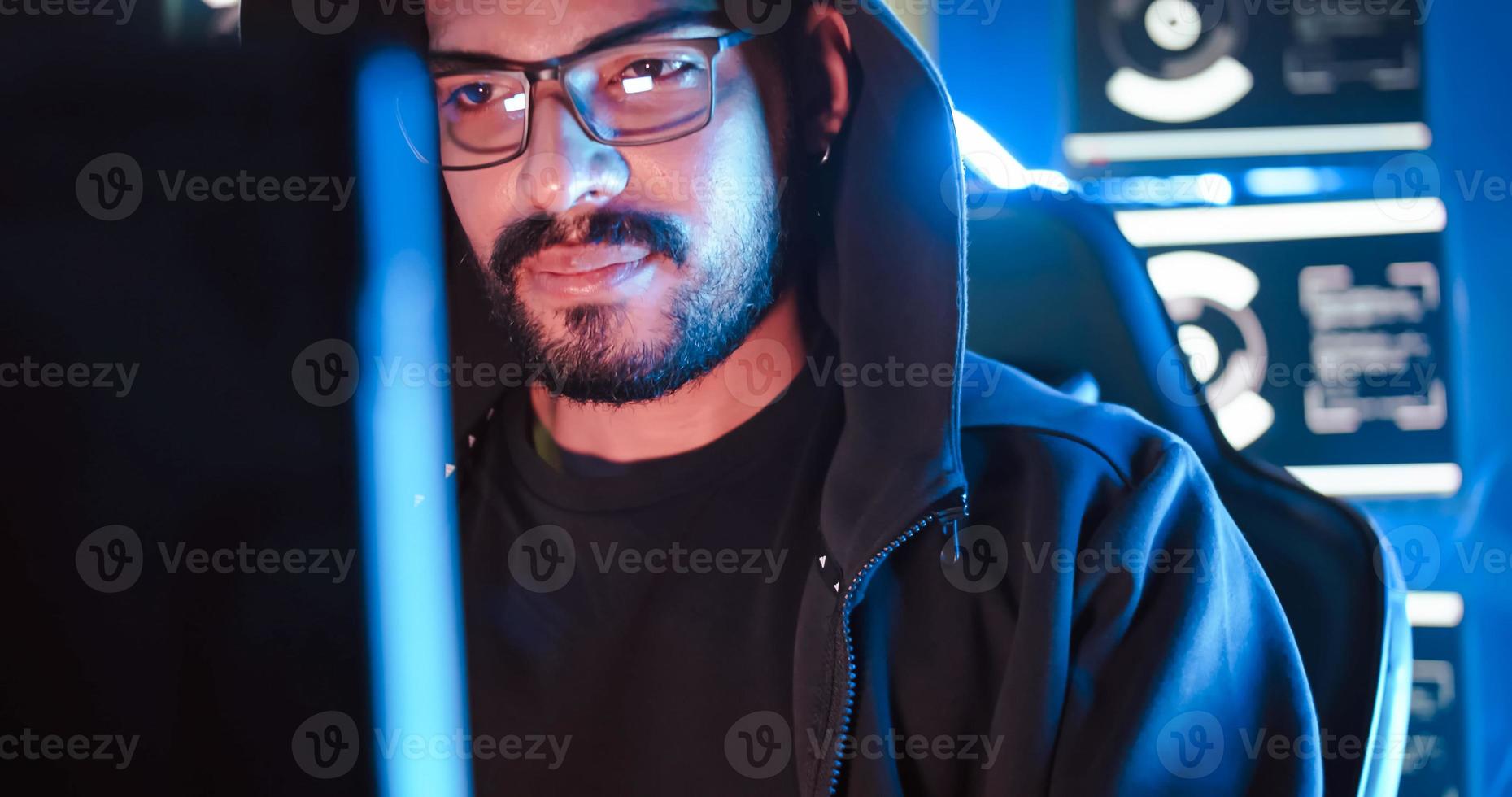 A male hacker is using a computer to hack data to demand ransom from victims. photo