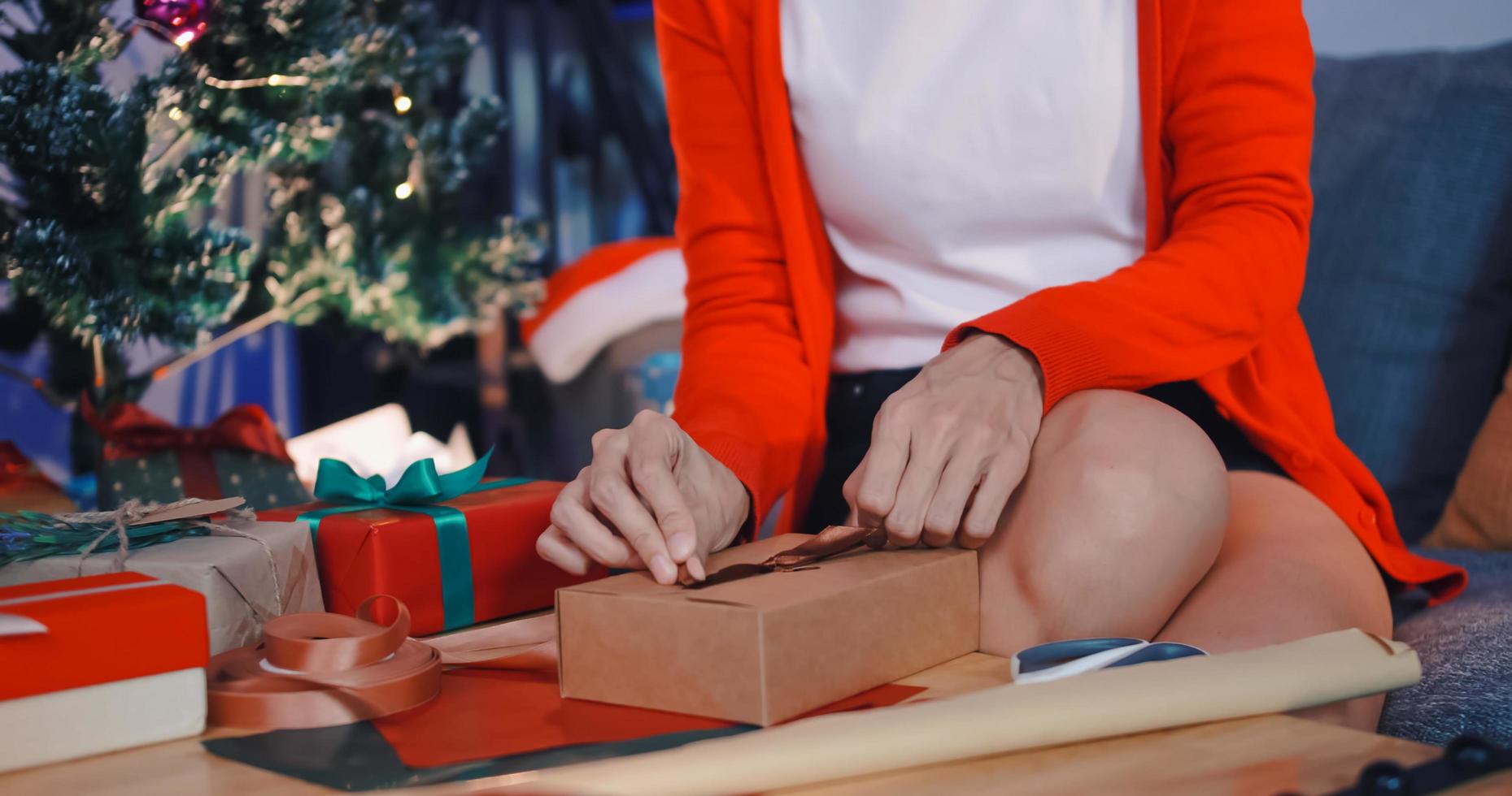 woman preparing presents for friends at Christmas party at home. photo