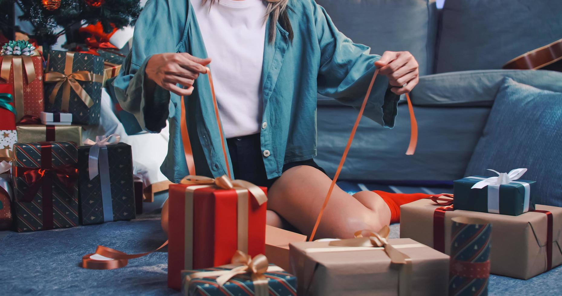 woman preparing presents for friends at Christmas party at home. photo