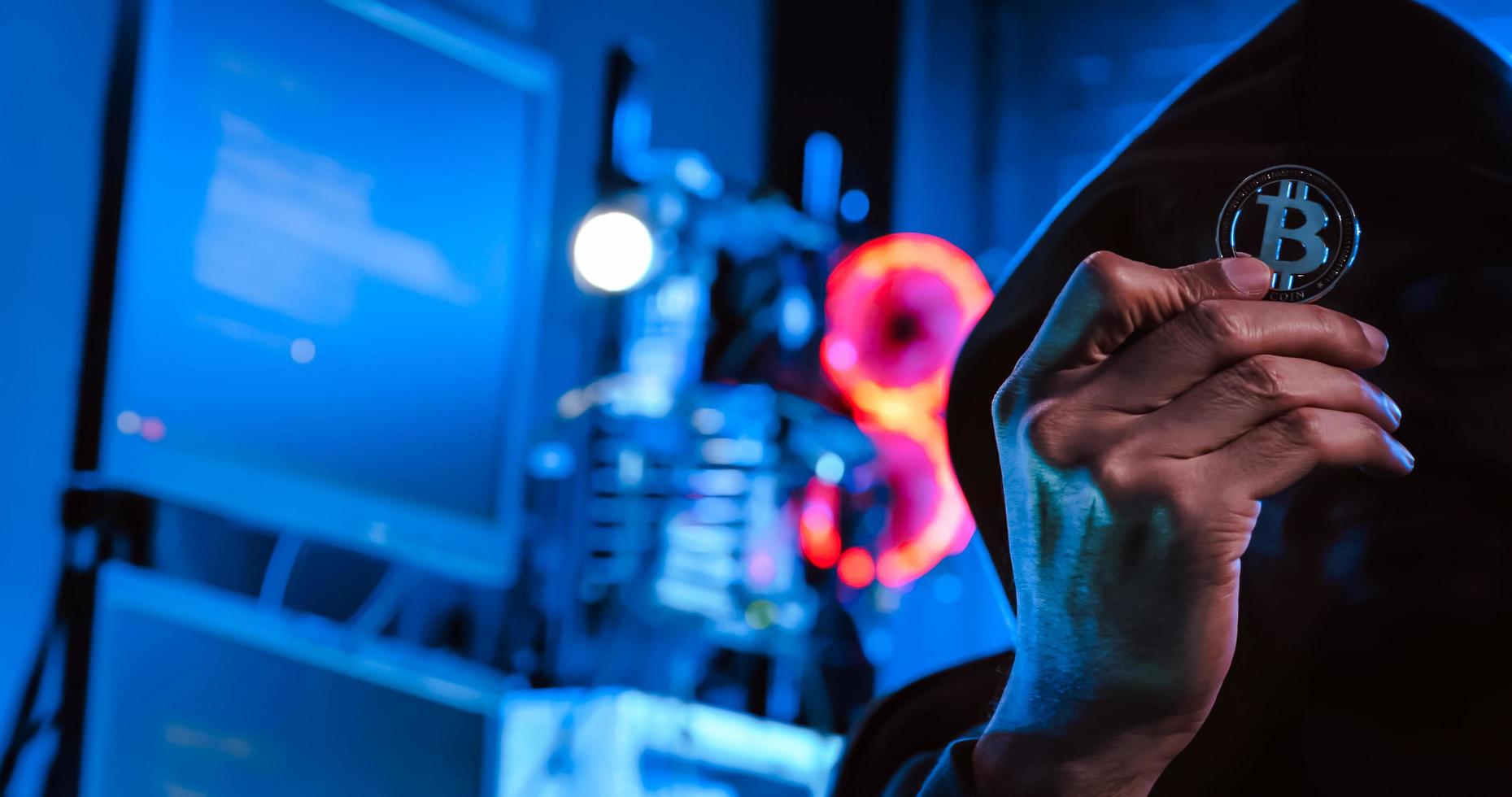 A male hacker is using a computer to hack data to demand ransom from victims. photo