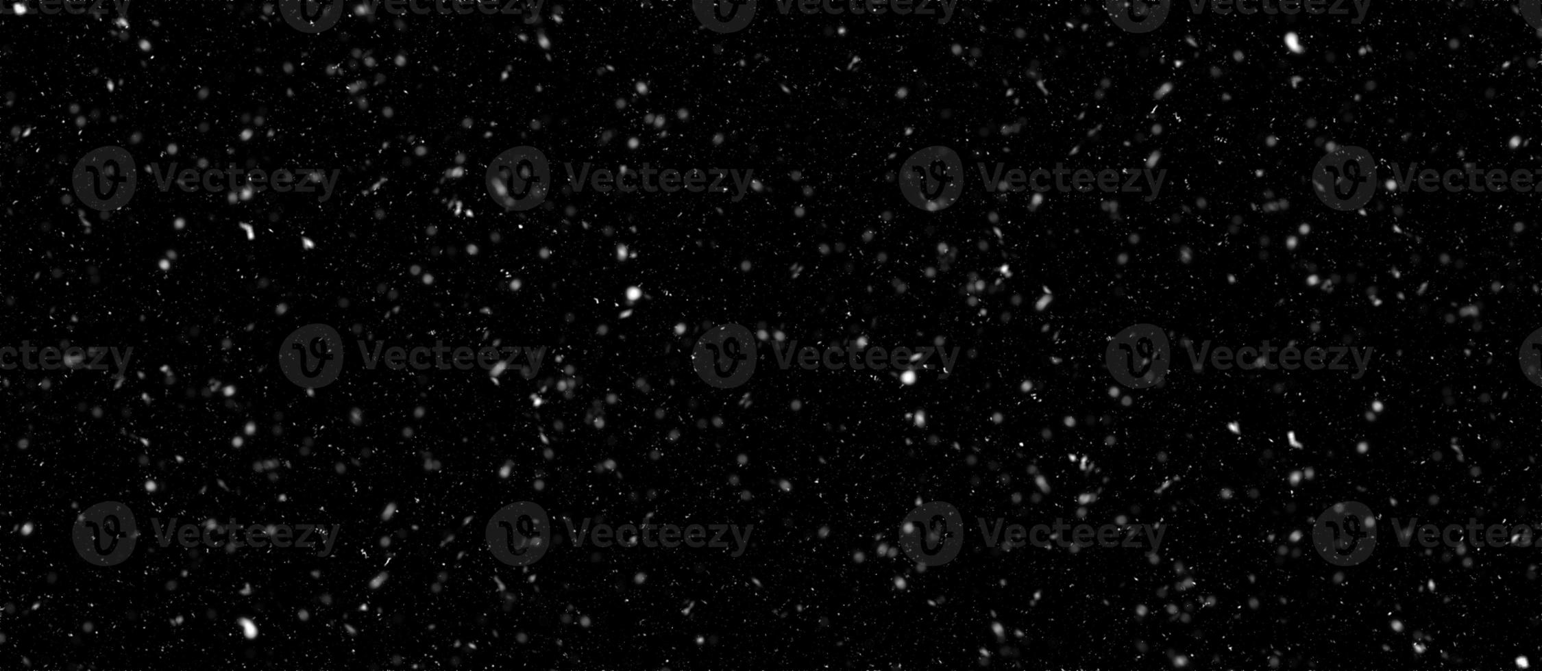 Snowfall bokeh on black background. Many snowflakes in flying in the air. Winte night snowfall and blizzard of snow at. Blur bokeh light effect creative background. photo