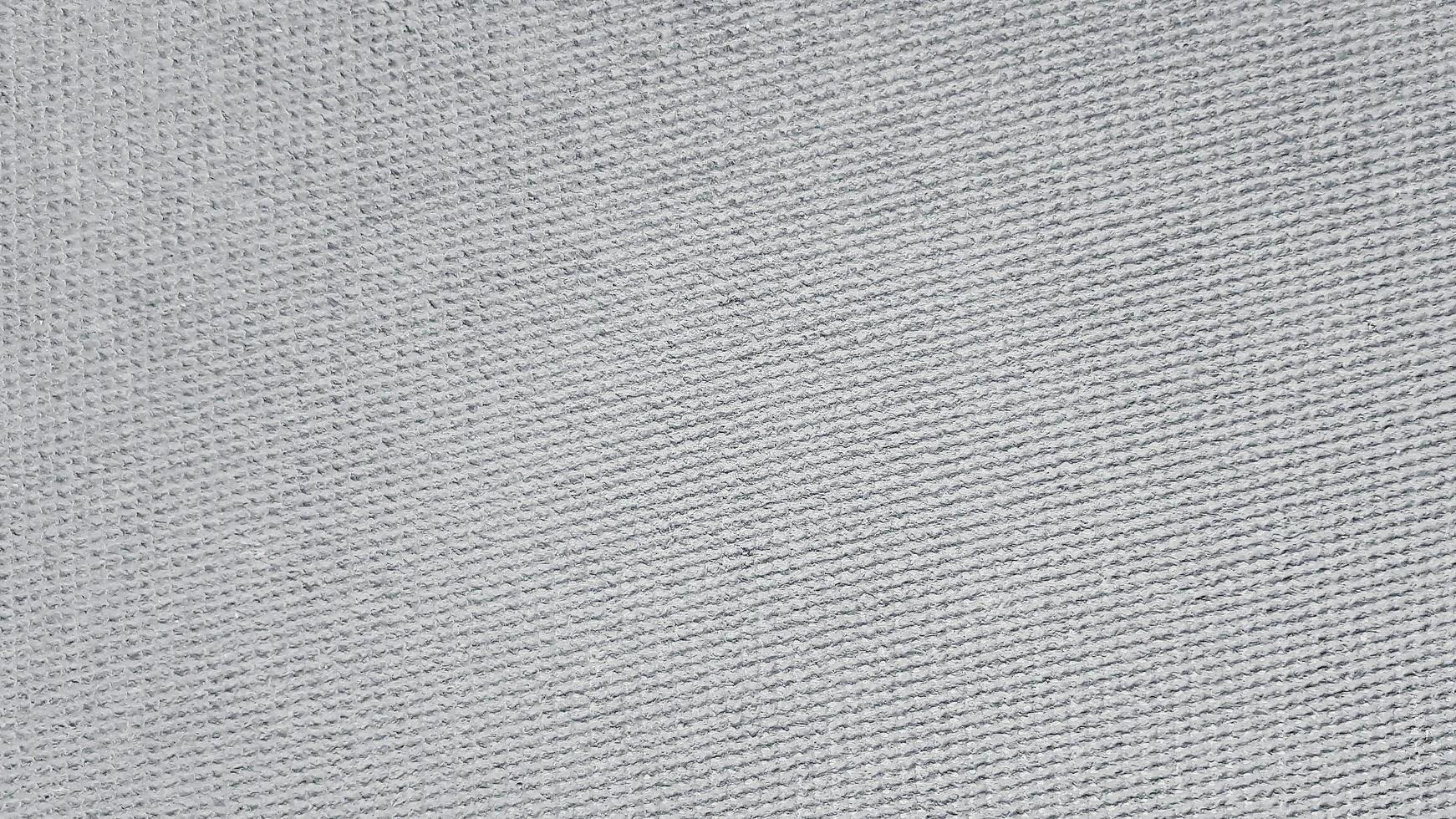 Textured of Gray or grey wool carpet or rug for background, wall or wallpaper in black and white or monochrome. Soft material and Pattern concept photo